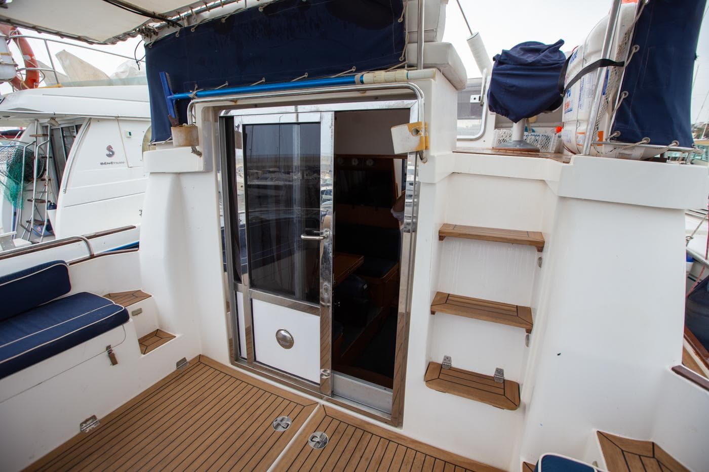 2005 Nimbus 380 Commander yacht deck with wooden flooring and sliding glass door.