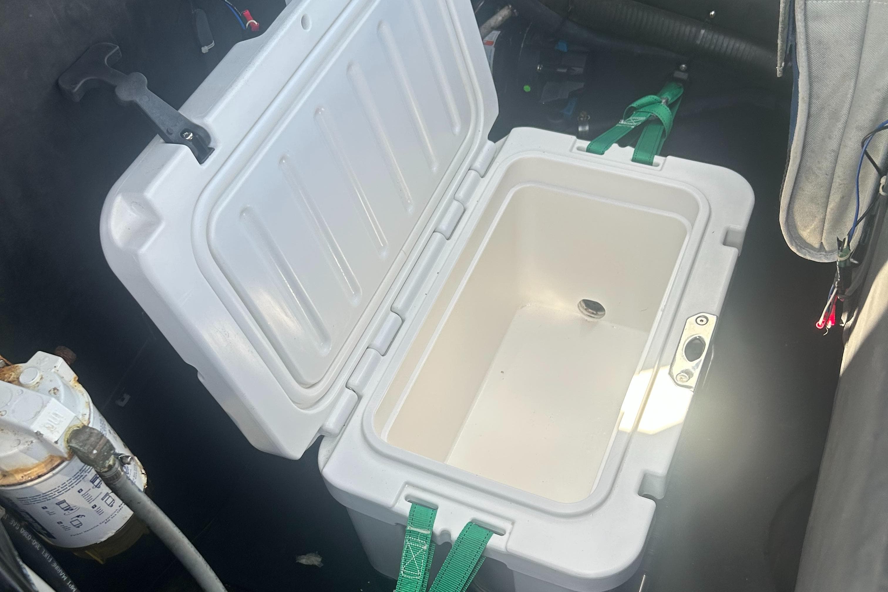 Open white cooler inside a 2008 RIB U-23 Carbon Hull boat.