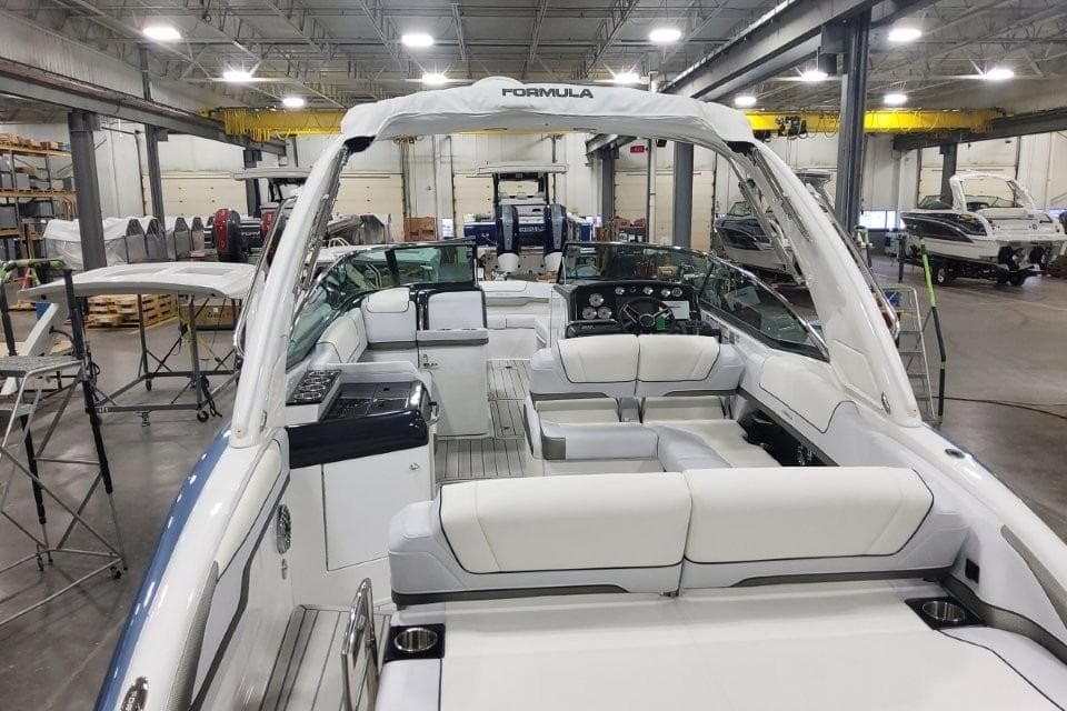 2026 Formula 310 Bowrider boat interior in a spacious warehouse setting.