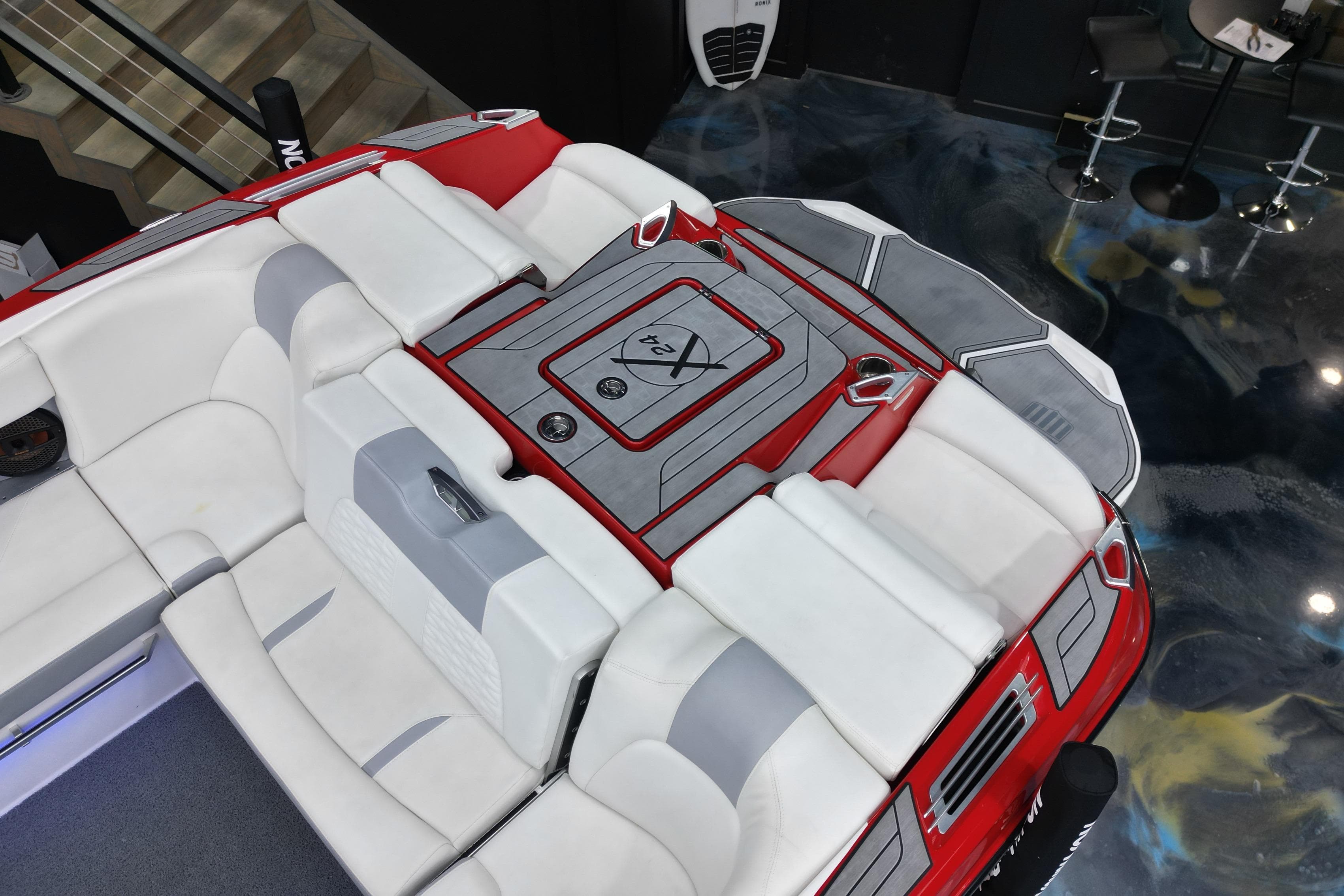 2022 MasterCraft X24 boat interior with red and white seating, viewed from above.