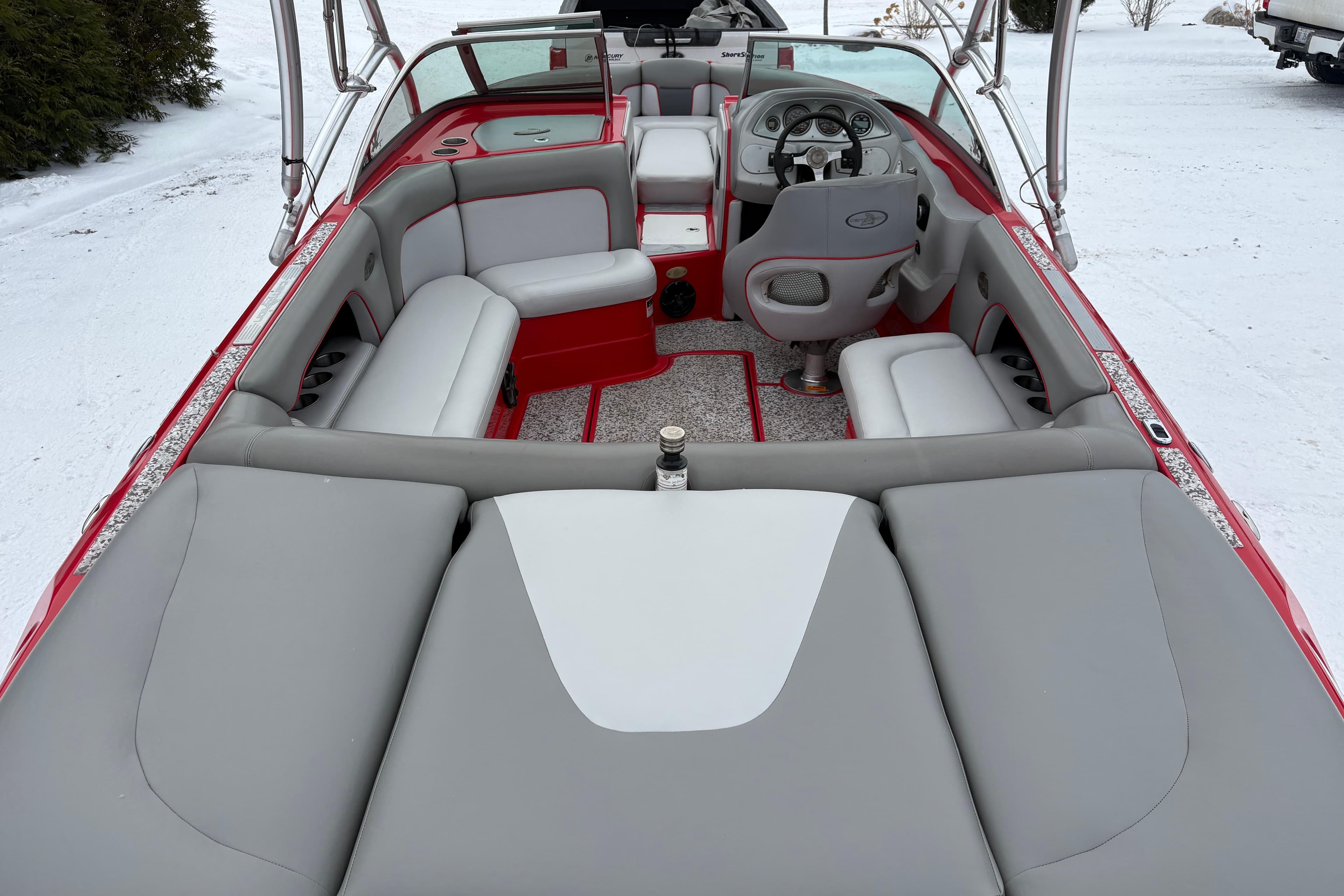 2006 Centurion Enzo SV230 boat interior with red and gray seating, snowy background.