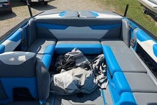 2020 Axis A22 boat interior with blue and gray seating, outdoor setting.