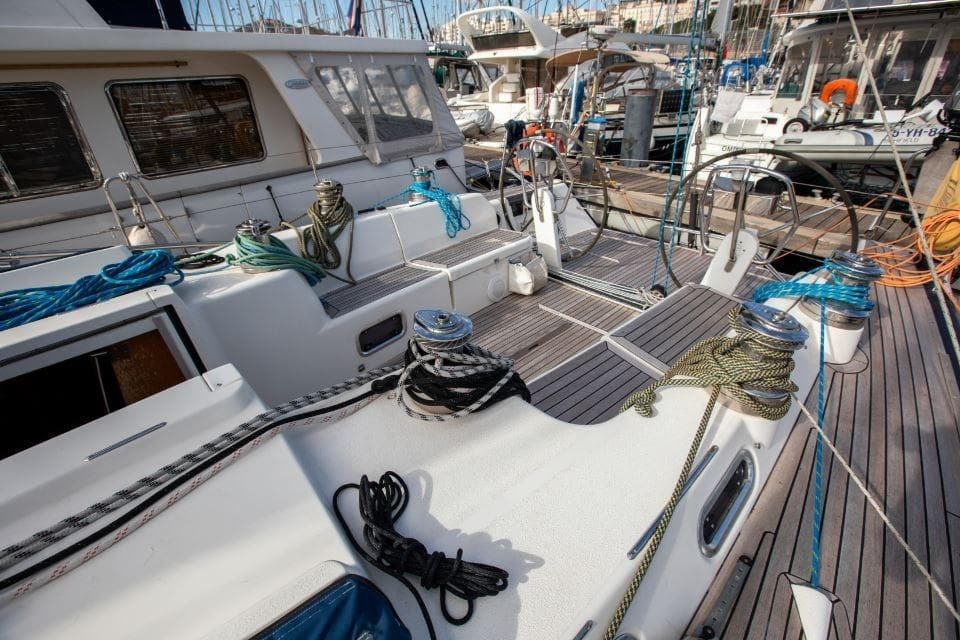 2005 X-Yachts 50 sailboat deck with ropes and winches in marina.