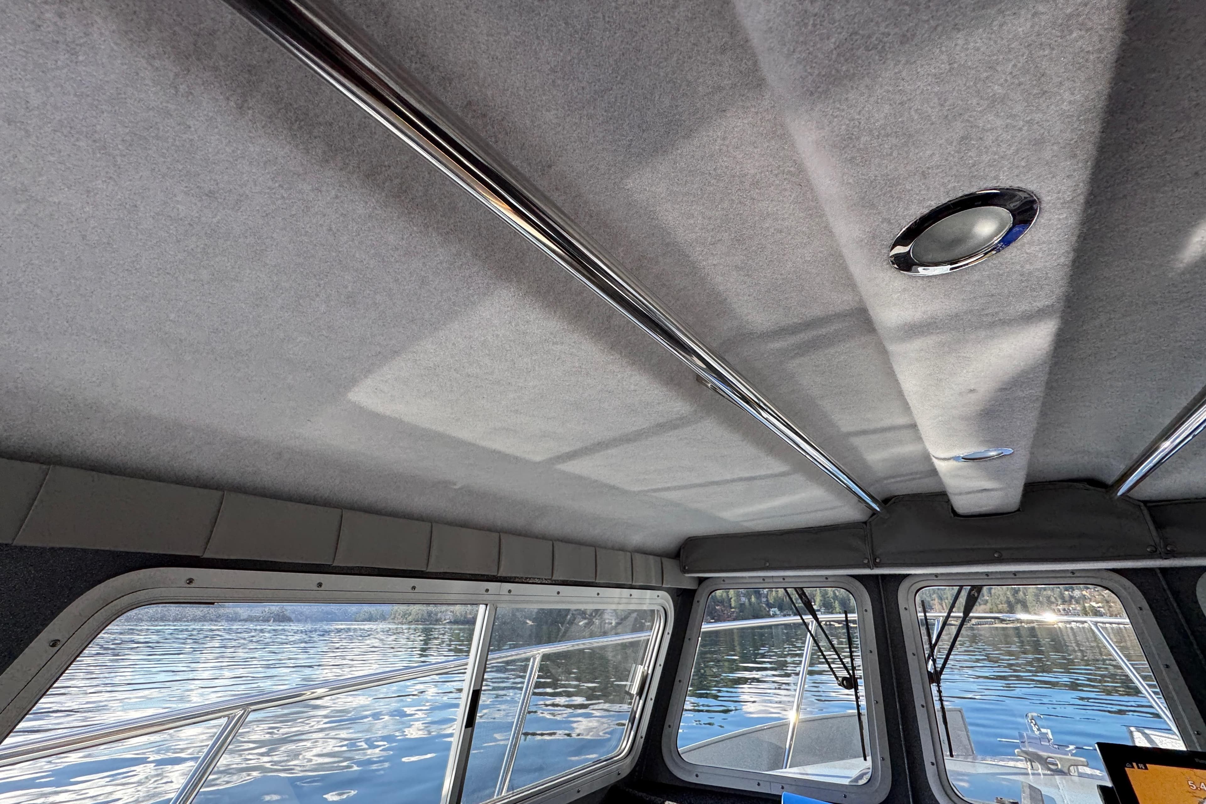 Interior view of 2018 KingFisher 2725 Weekender boat with windows overlooking water.