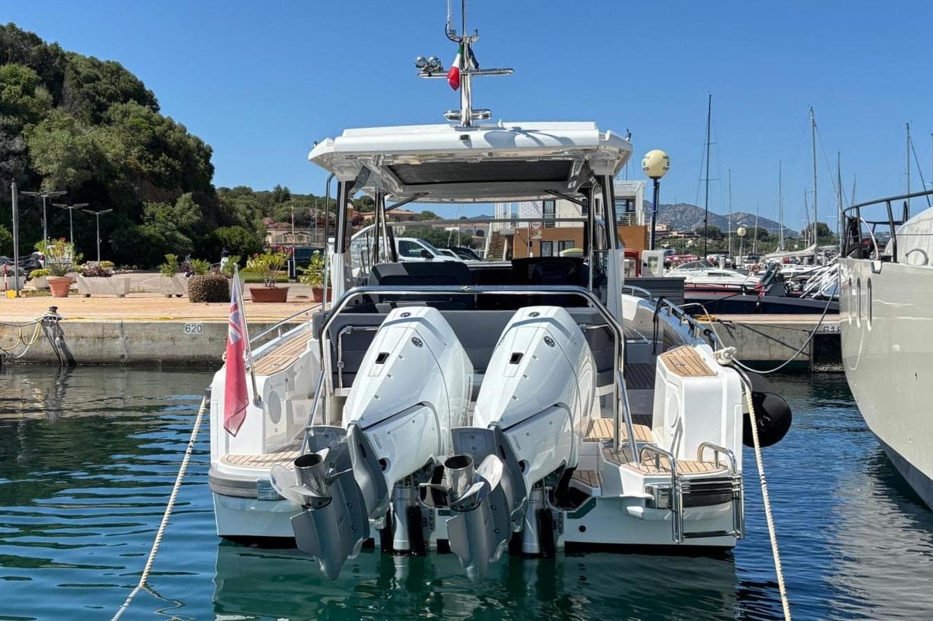 2025 Nimbus Weekender 11 docked, featuring dual outboard motors and sleek design.