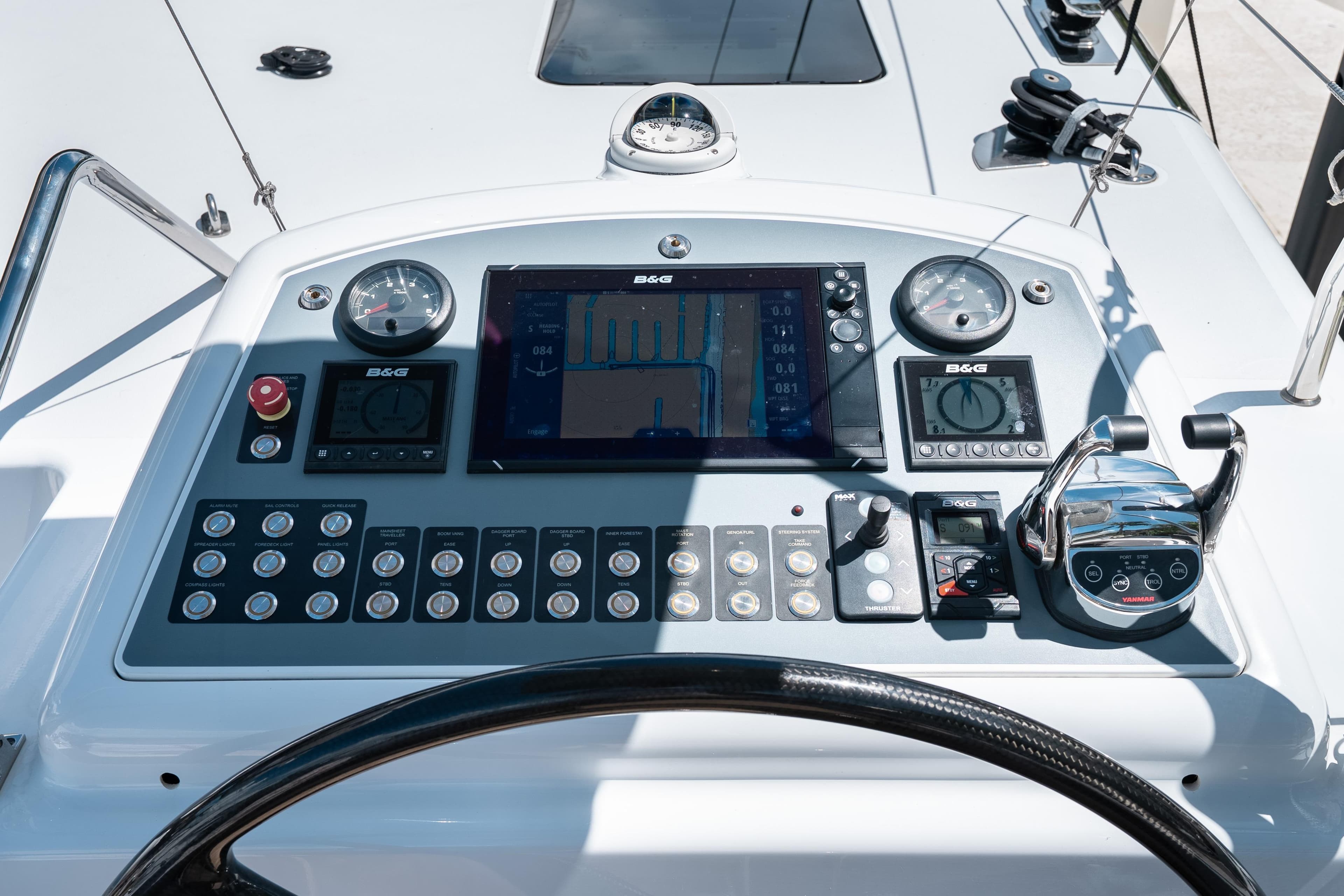 Control panel of Ocean Explorer Catamarans with navigation instruments and steering wheel.