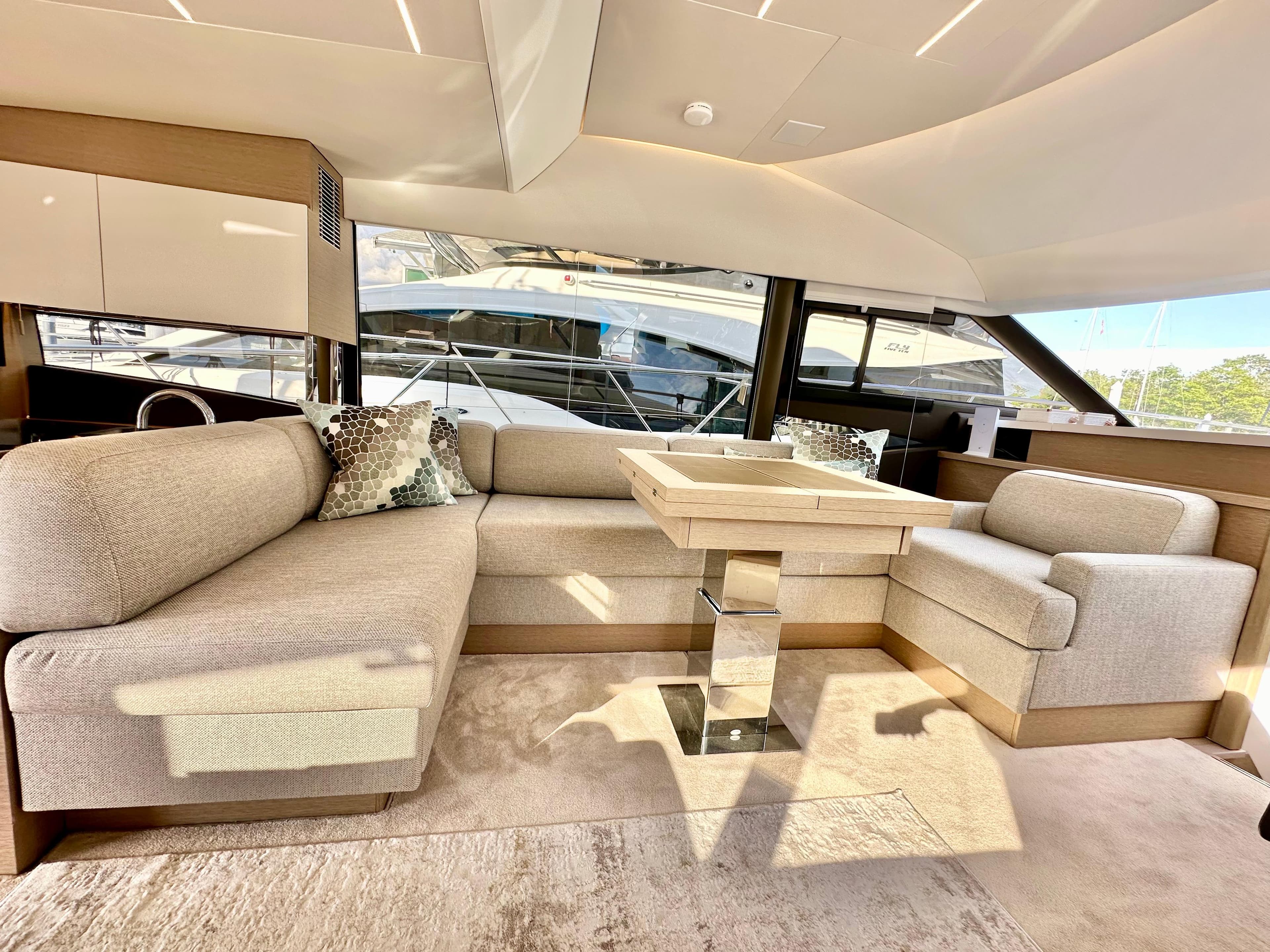 Luxurious interior of 2023 Prestige 520 yacht with elegant seating and modern design.