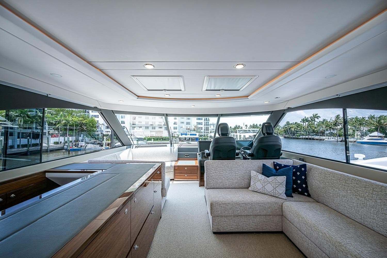 Luxurious interior of 2025 Maritimo M75 yacht with modern seating and panoramic windows.