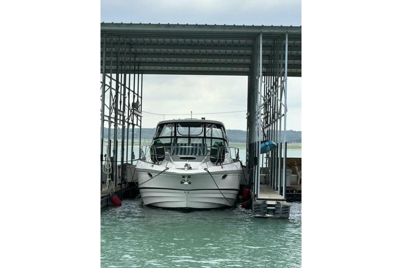 2007 Regal Commodore 4460 yacht docked in a covered marina slip.