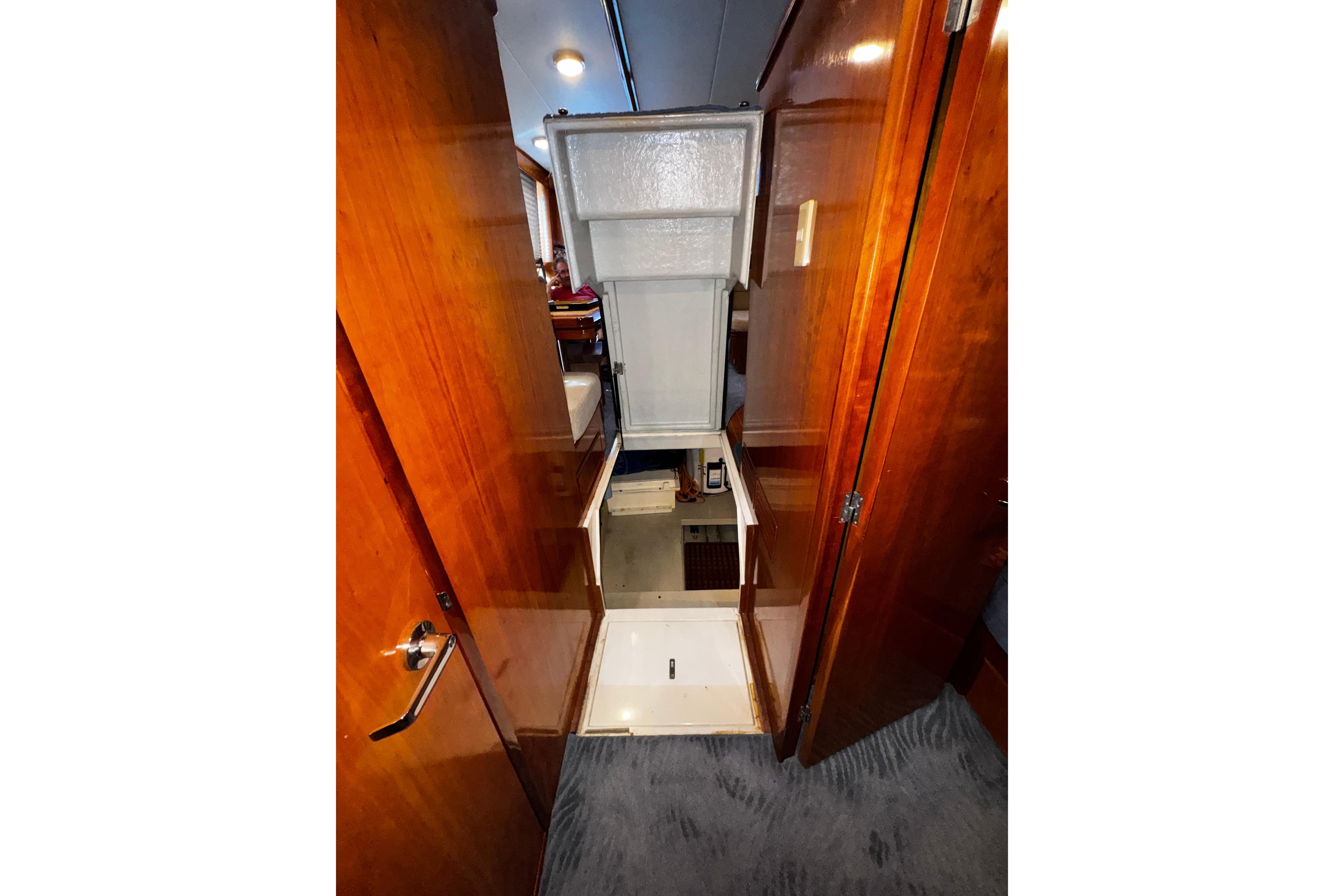 Interior view of 1998 Mikelson 43 Sportfisher yacht with wooden cabinetry and carpeted flooring.