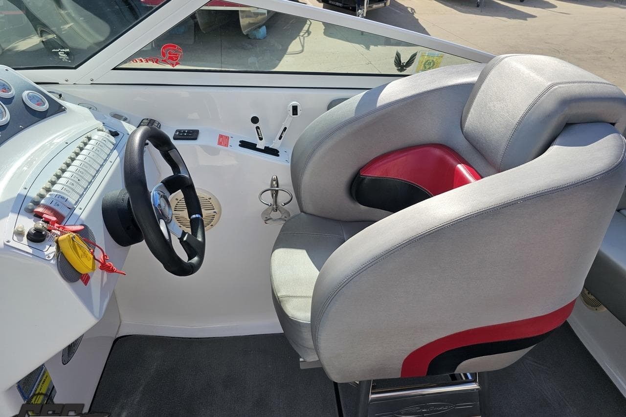 Interior of a 2006 Powerquest 240 Ultra LX boat showing steering wheel and seat.