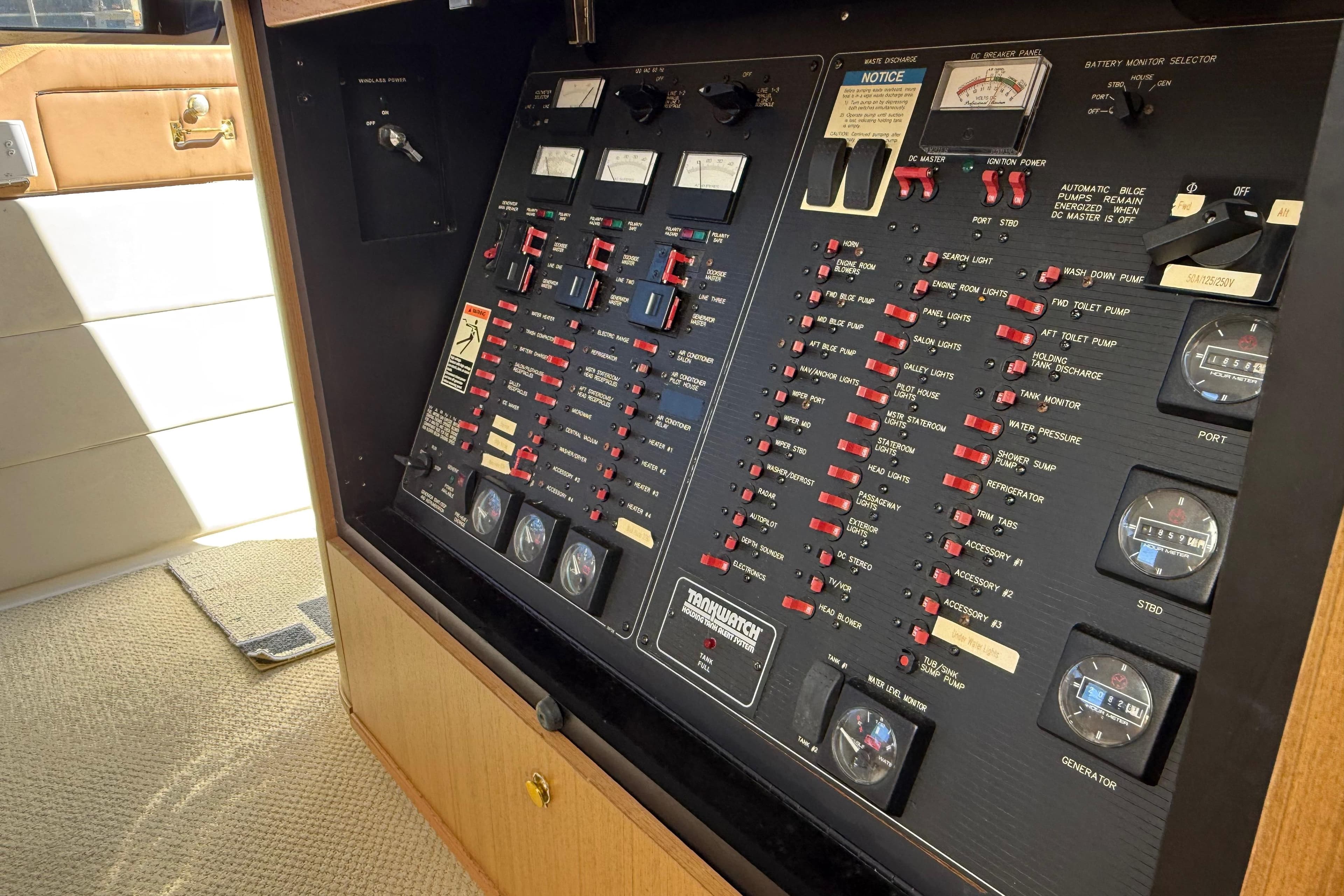 Control panel of a 2002 Bayliner 4788 Pilot House Motoryacht, featuring various switches and gauges.