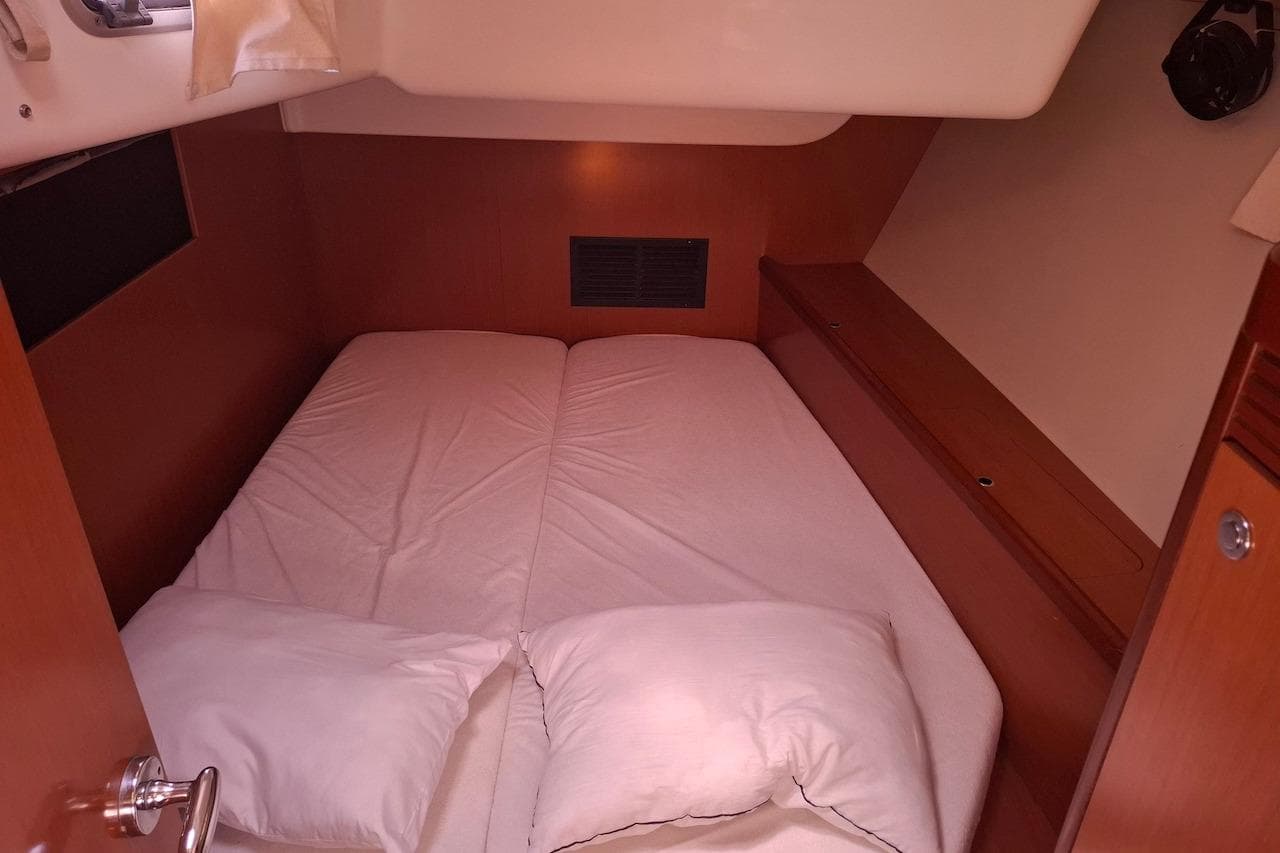 Cozy cabin interior of 2009 Beneteau Oceanis 54 sailboat with double bed.