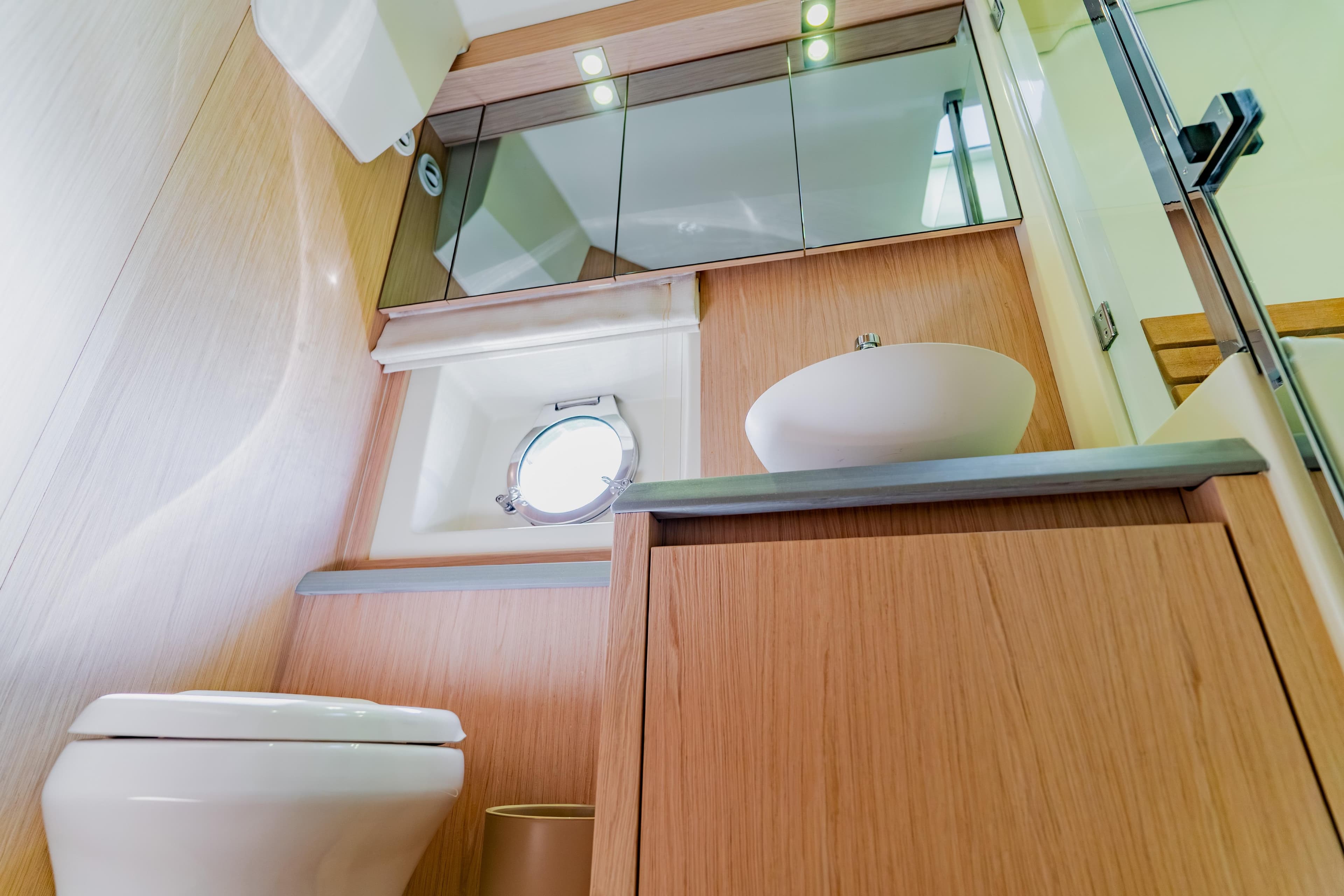 Luxurious bathroom in 2015 Monte Carlo MC5 yacht with modern fixtures and wooden cabinetry.