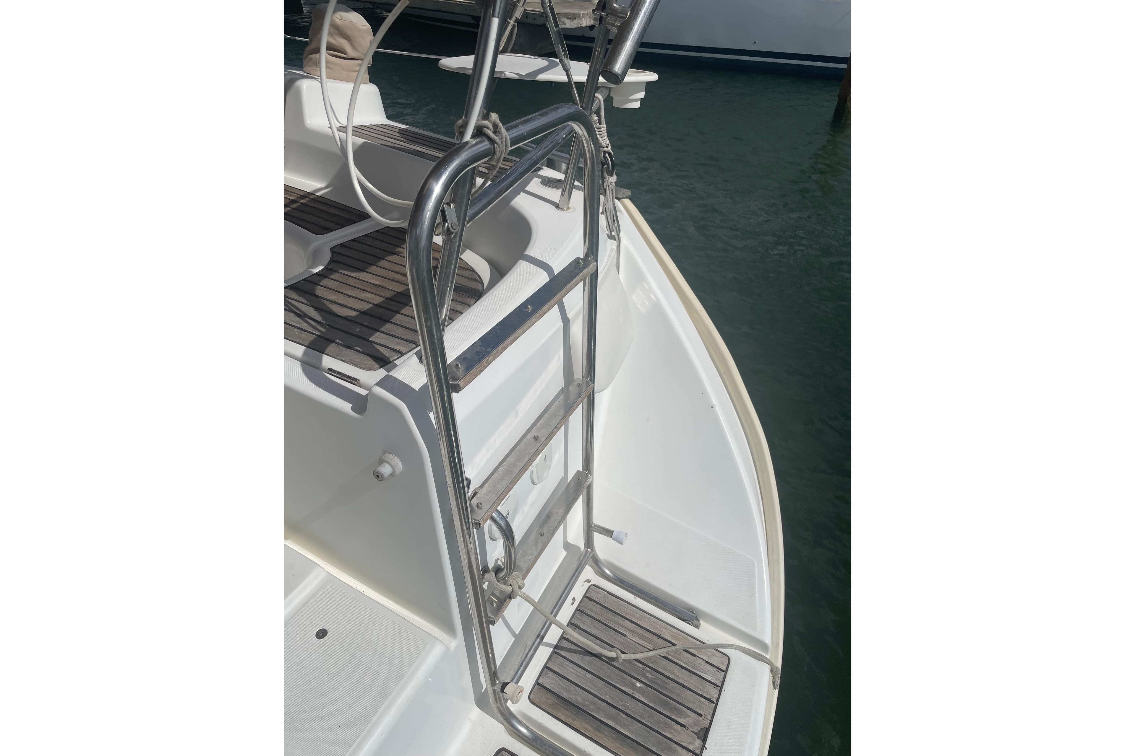 Stainless steel ladder on 2007 Beneteau 423 yacht, docked by the water.
