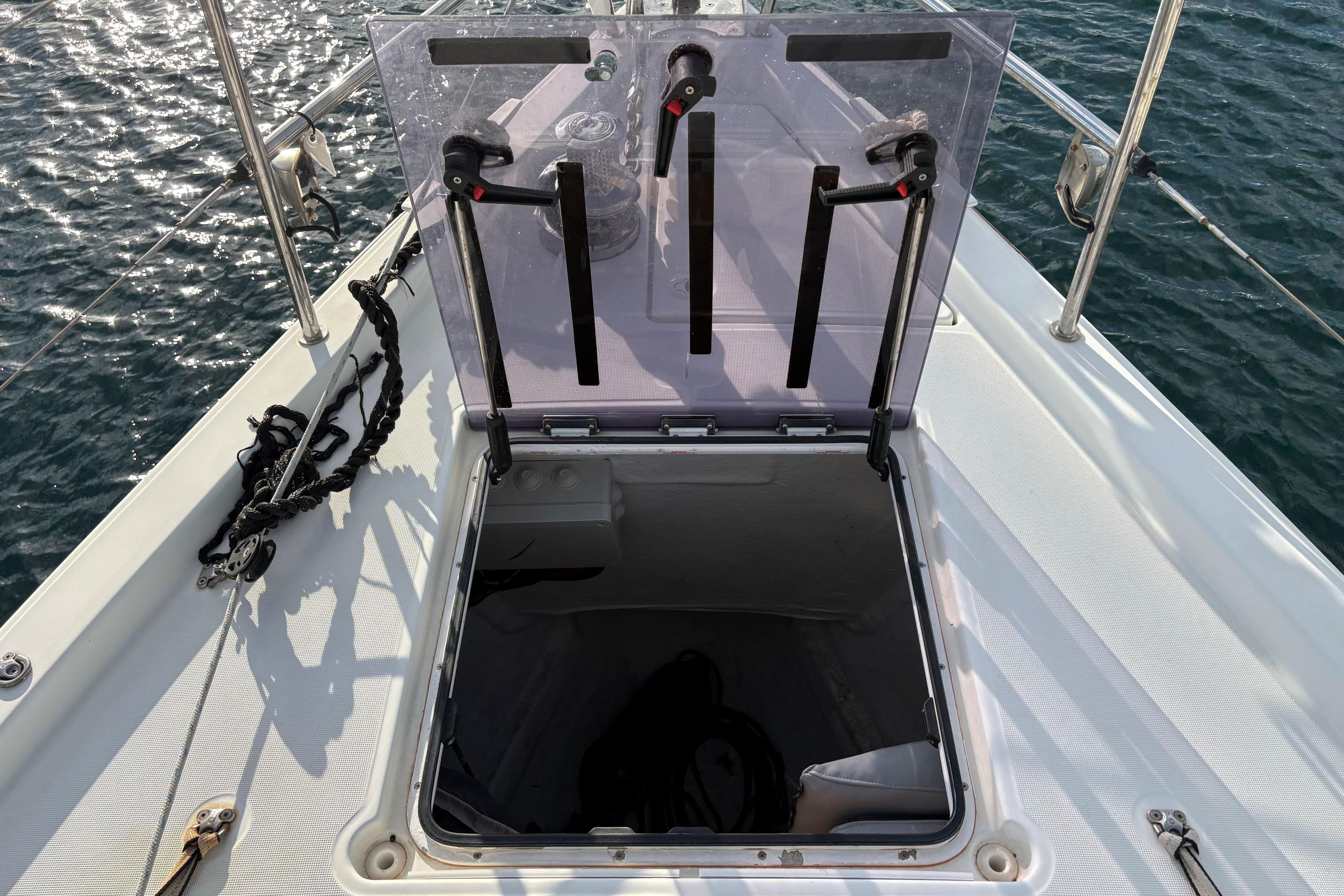 Open hatch on 2017 Jeanneau 51 sailboat deck, overlooking ocean water.