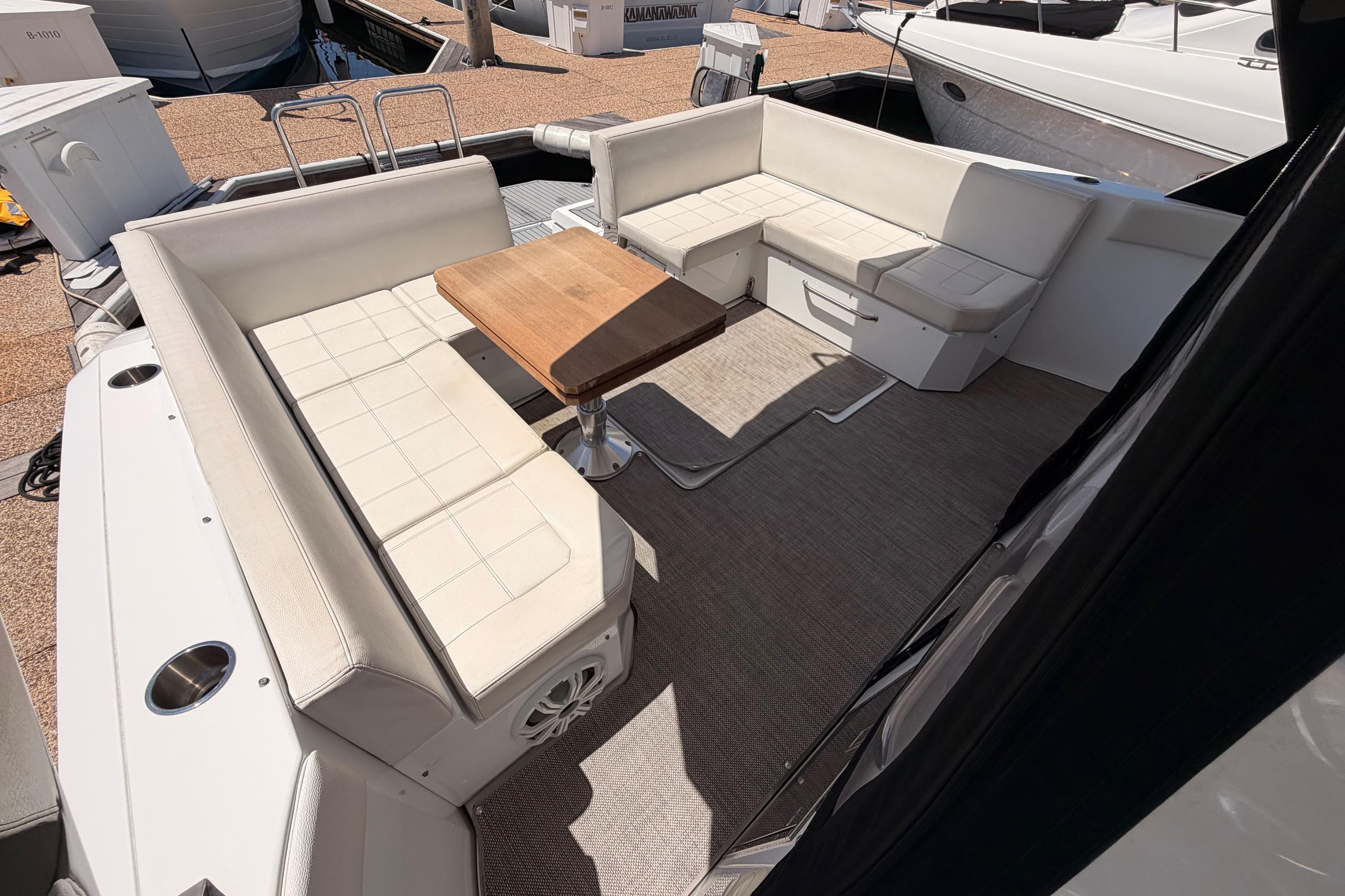 2020 Cruisers Yachts 390 Express Coupe interior with white seating and wooden table.