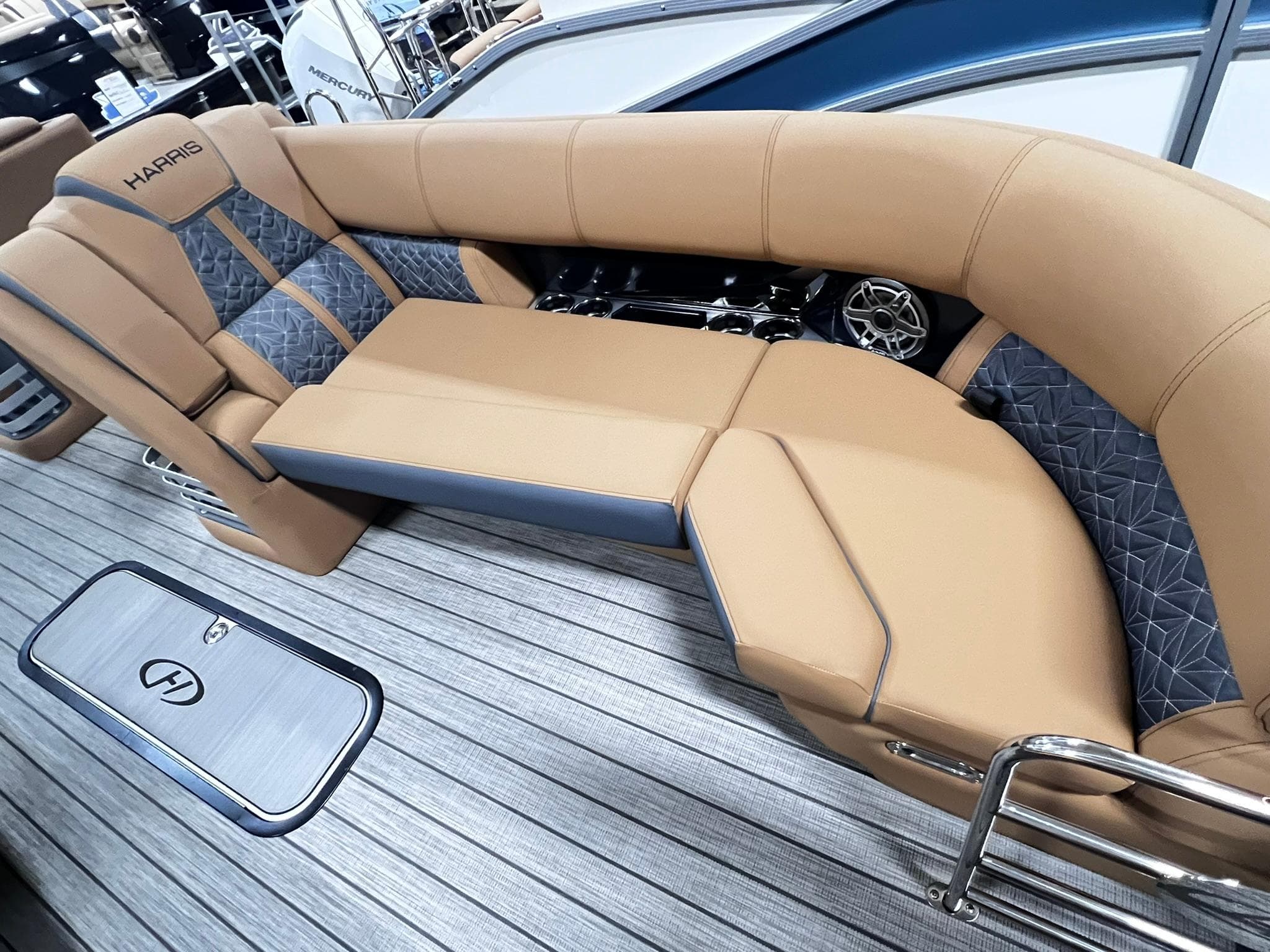 Luxurious seating on 2024 Harris 250 Grand Mariner V10 400 boat, featuring tan and gray upholstery.