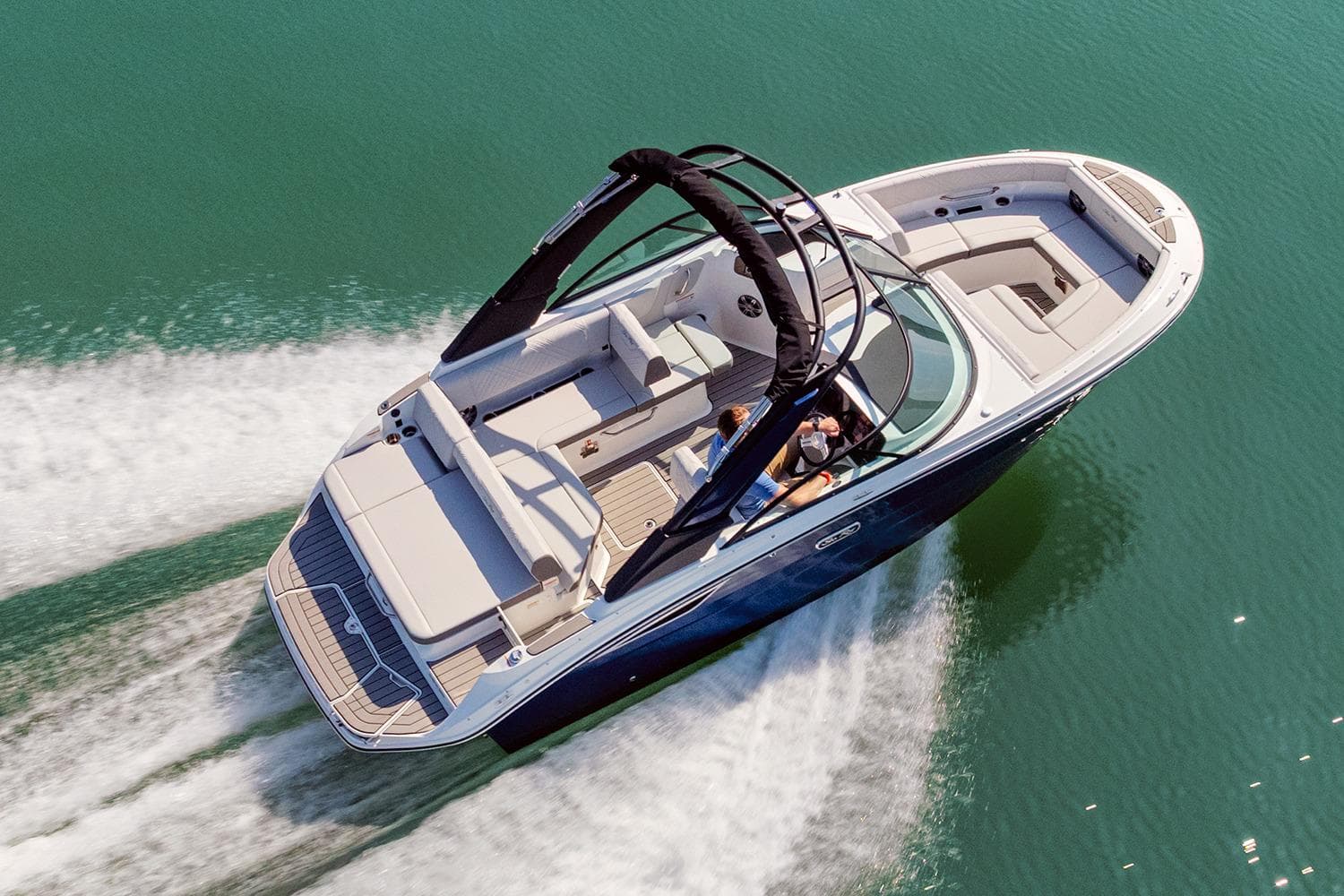 Manufacturer Provided Image: 2026 Sea Ray SDX 230 cruising on clear water, showcasing sleek design and spacious seating.