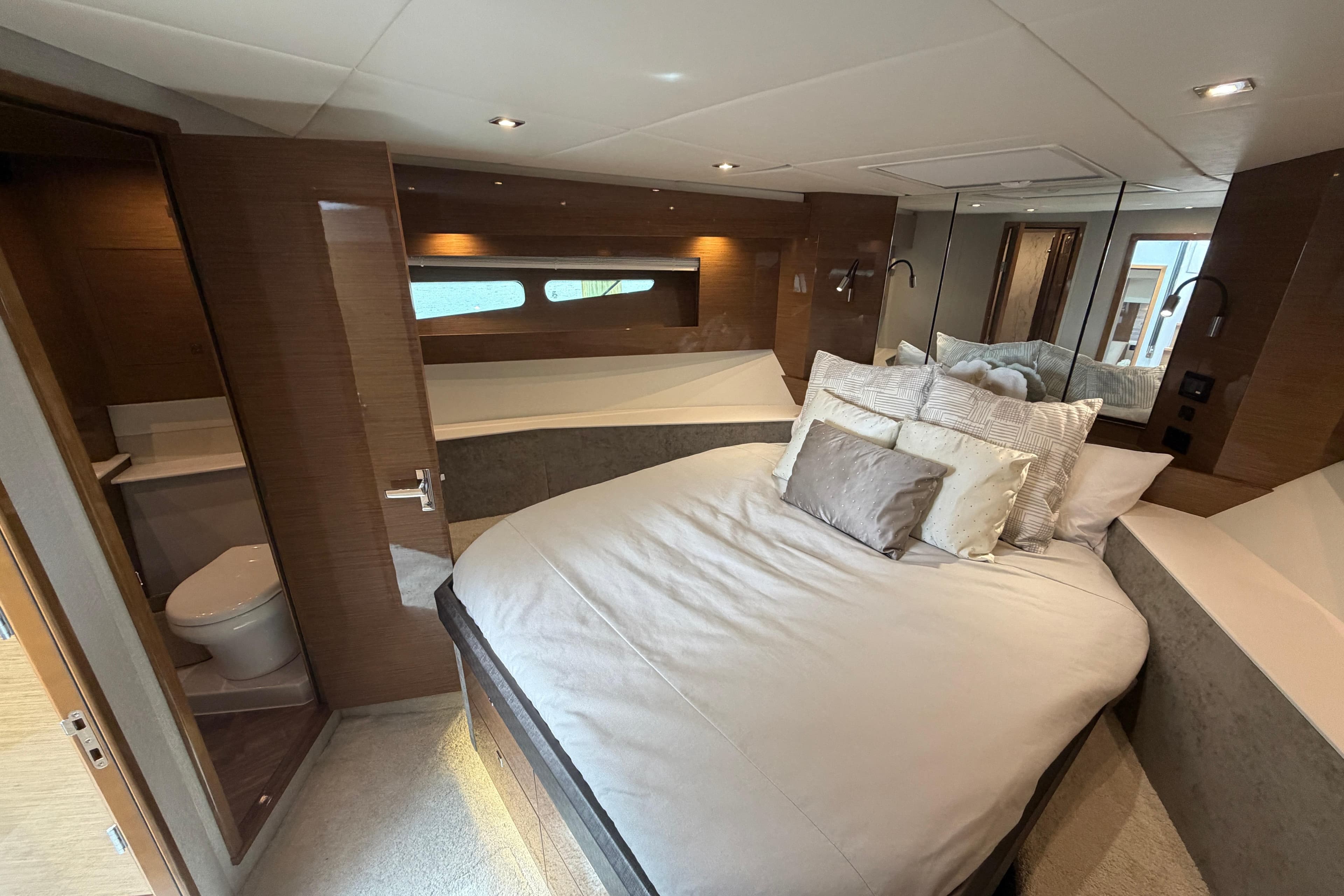 Luxurious bedroom interior of 2018 Cruisers Yachts 50 Cantius with elegant bedding and ensuite bathroom.