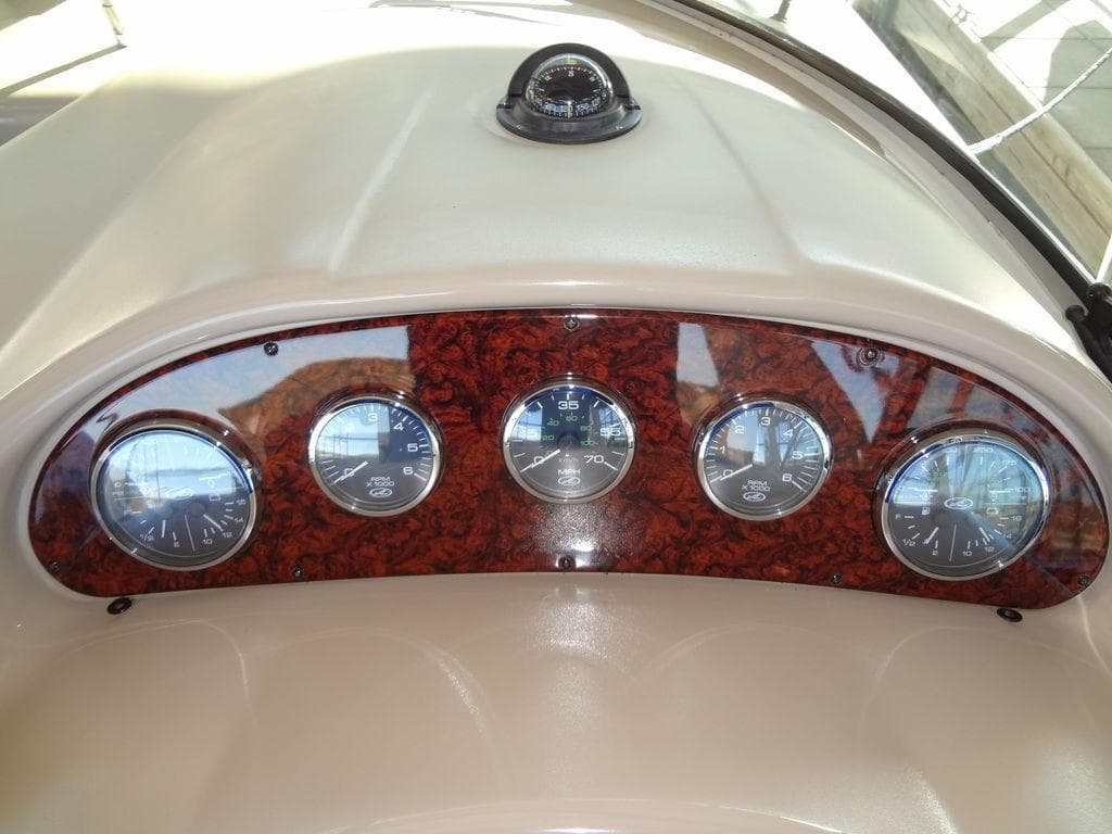 Dashboard of 2005 Sea Ray 320 Sundancer with gauges and compass.