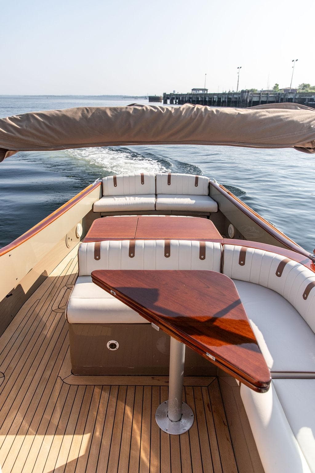 Hinckley Talaria 29R 2003 boat interior with elegant wood and white seating.