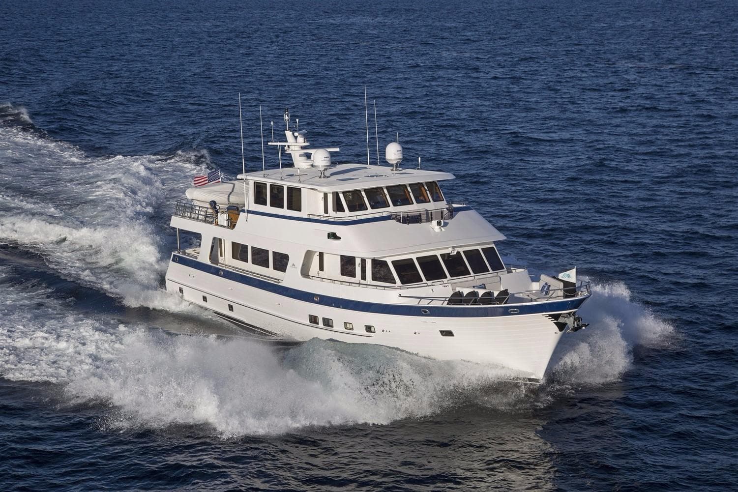 2027 Outer Reef Yachts 860 Deluxbridge Motoryacht cruising on open sea.