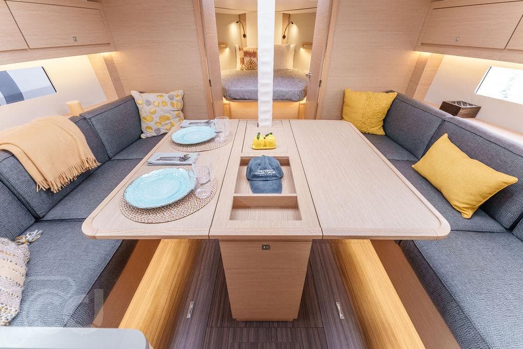 2023 Dufour 37 yacht interior with cozy dining area and modern decor.