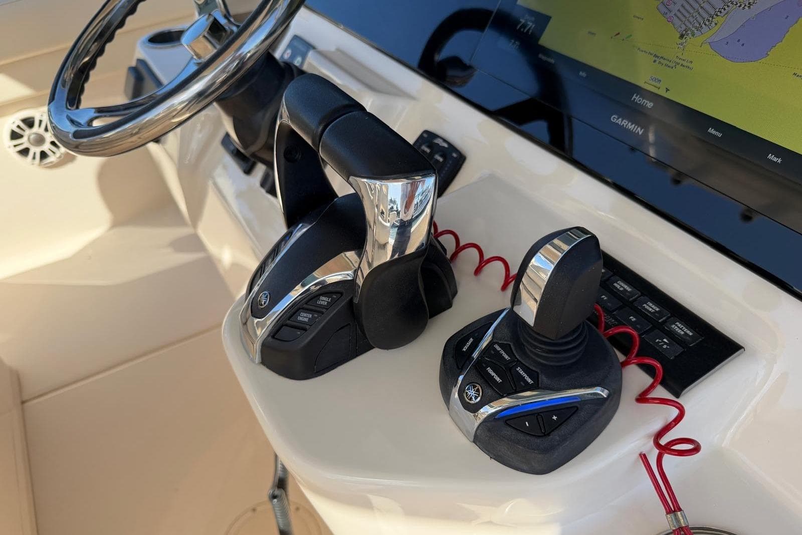 Control panel of 2021 Grady-White Canyon 326 boat with steering wheel and navigation system.