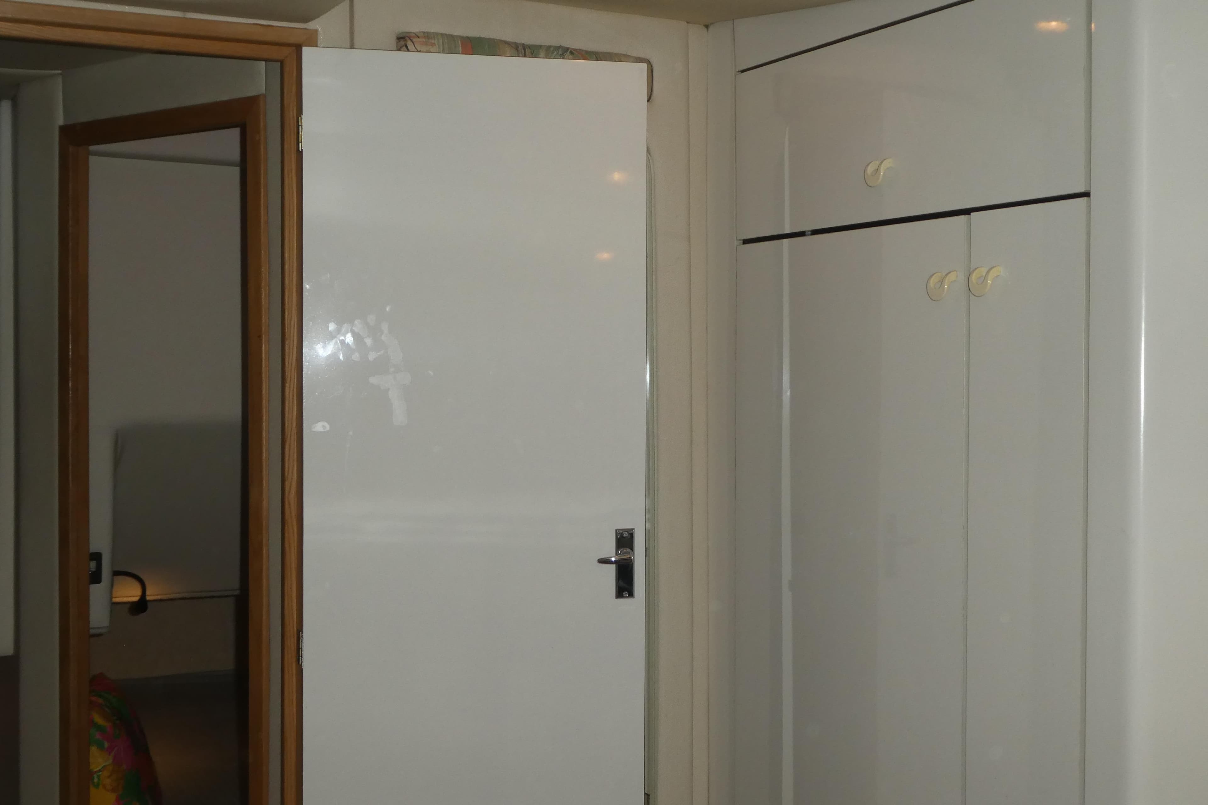 Interior of 1994 Bayliner 4388 Motor Yacht with white door and cabinets.