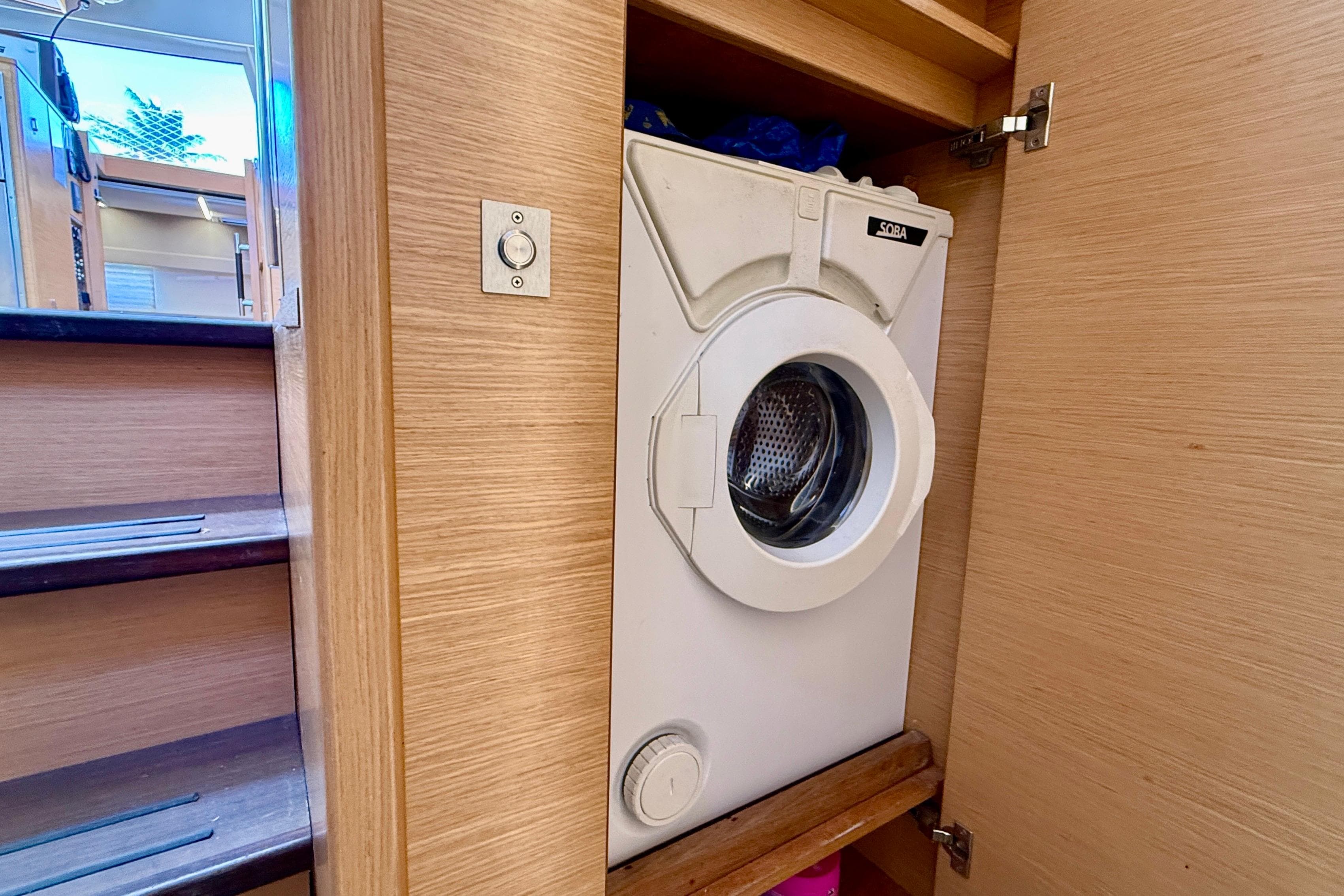 Washing machine in Nautitech 46 Open yacht, 2016 model, wooden interior.