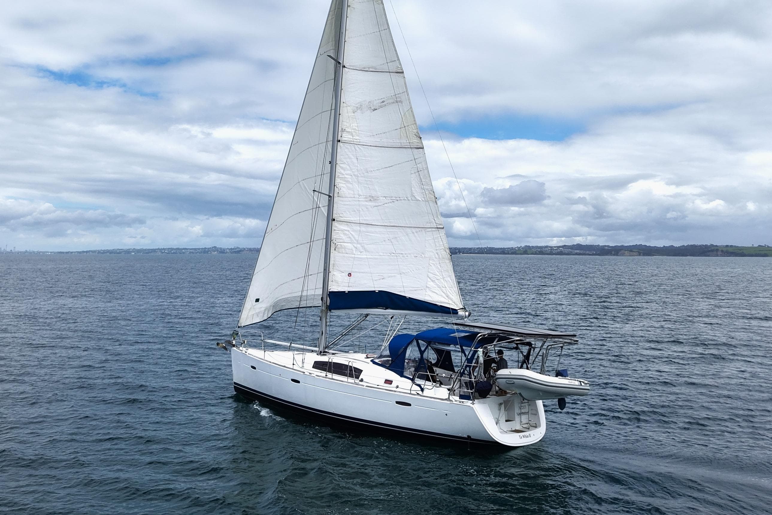 2009 Beneteau Oceanis 43 sailing on open water under cloudy skies.
