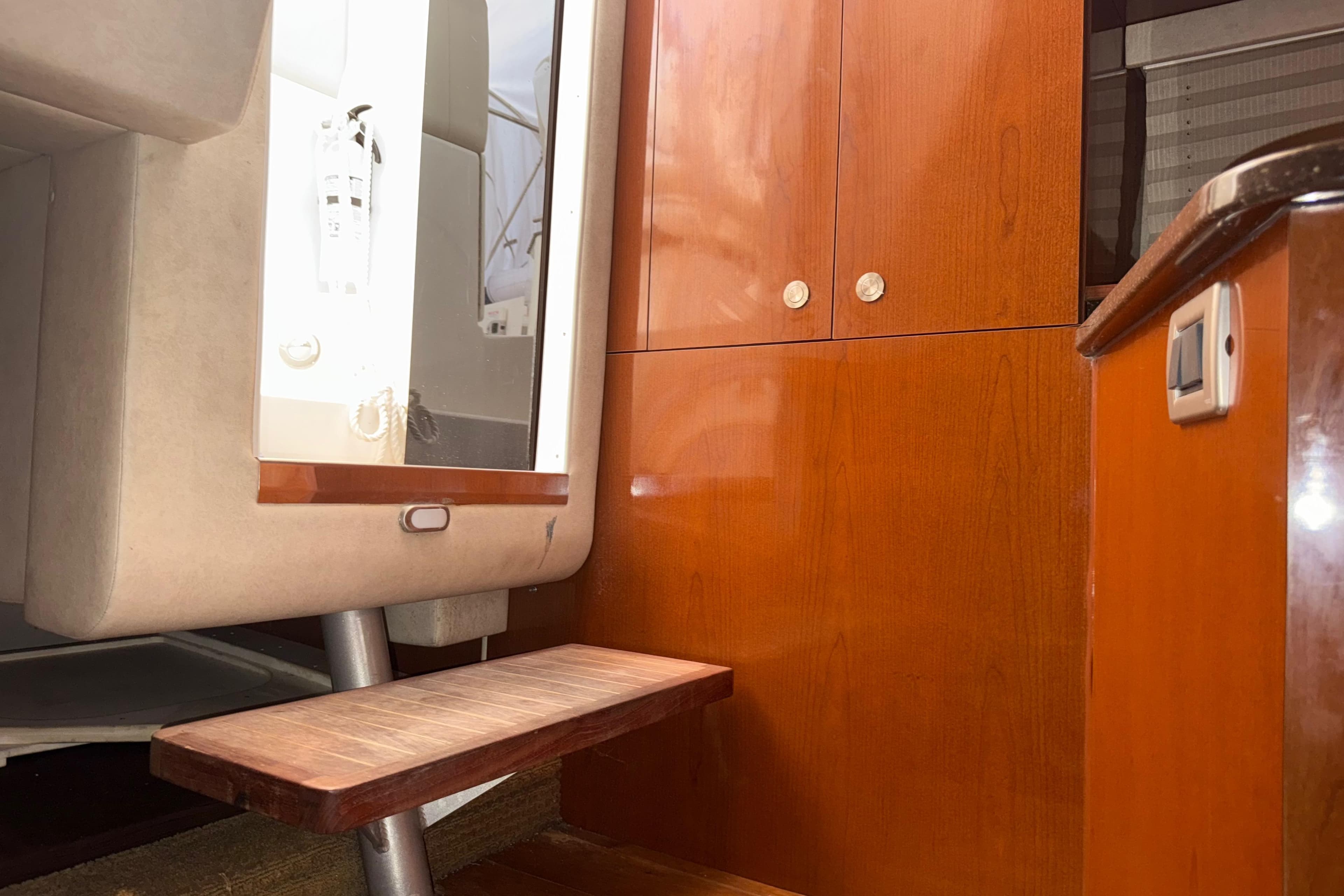 Interior of 2012 Sea Ray Sundancer 310, featuring wooden cabinetry and a small step.