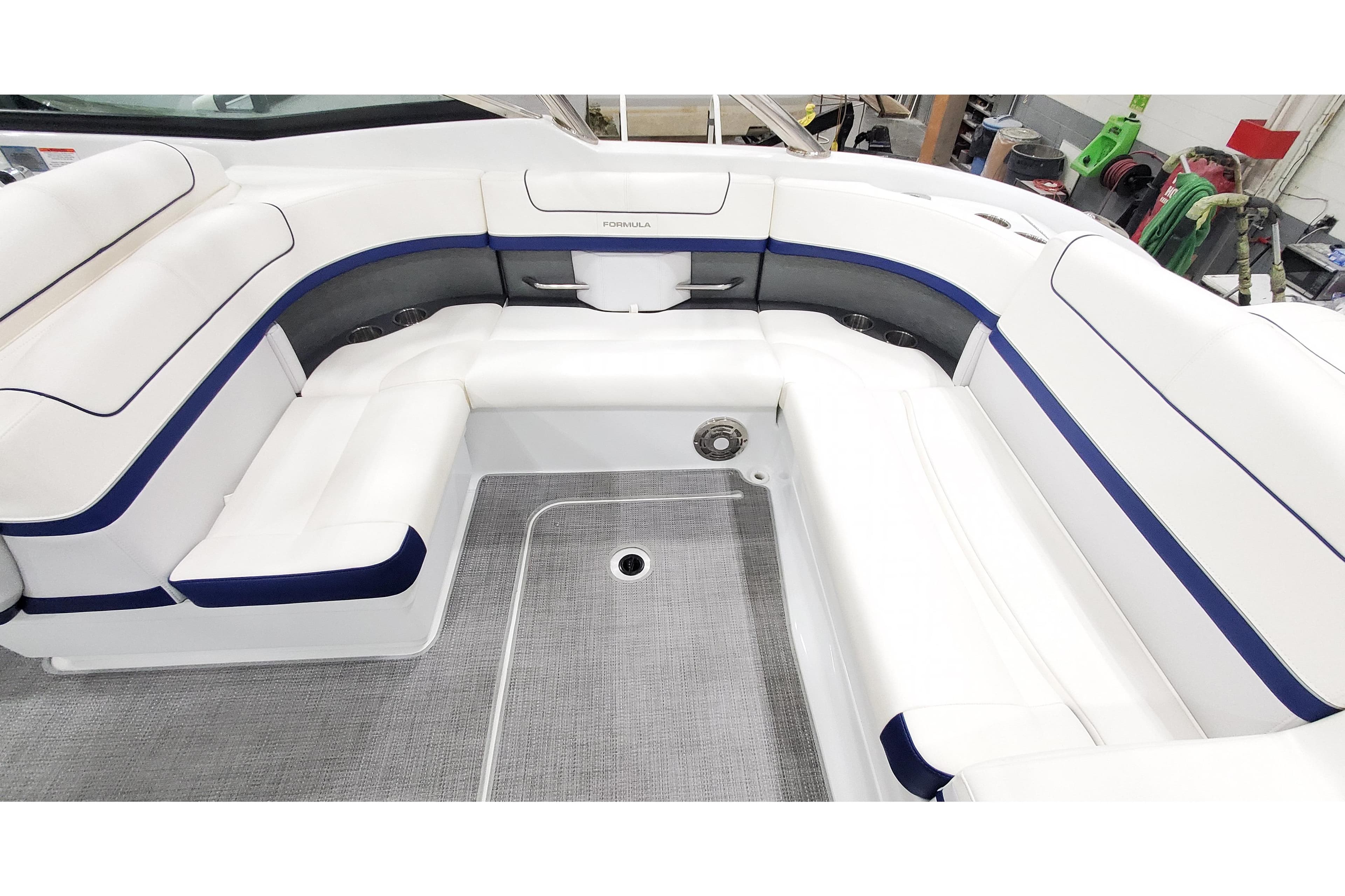 2013 Formula 310 Bowrider interior with white and blue seating, spacious layout.