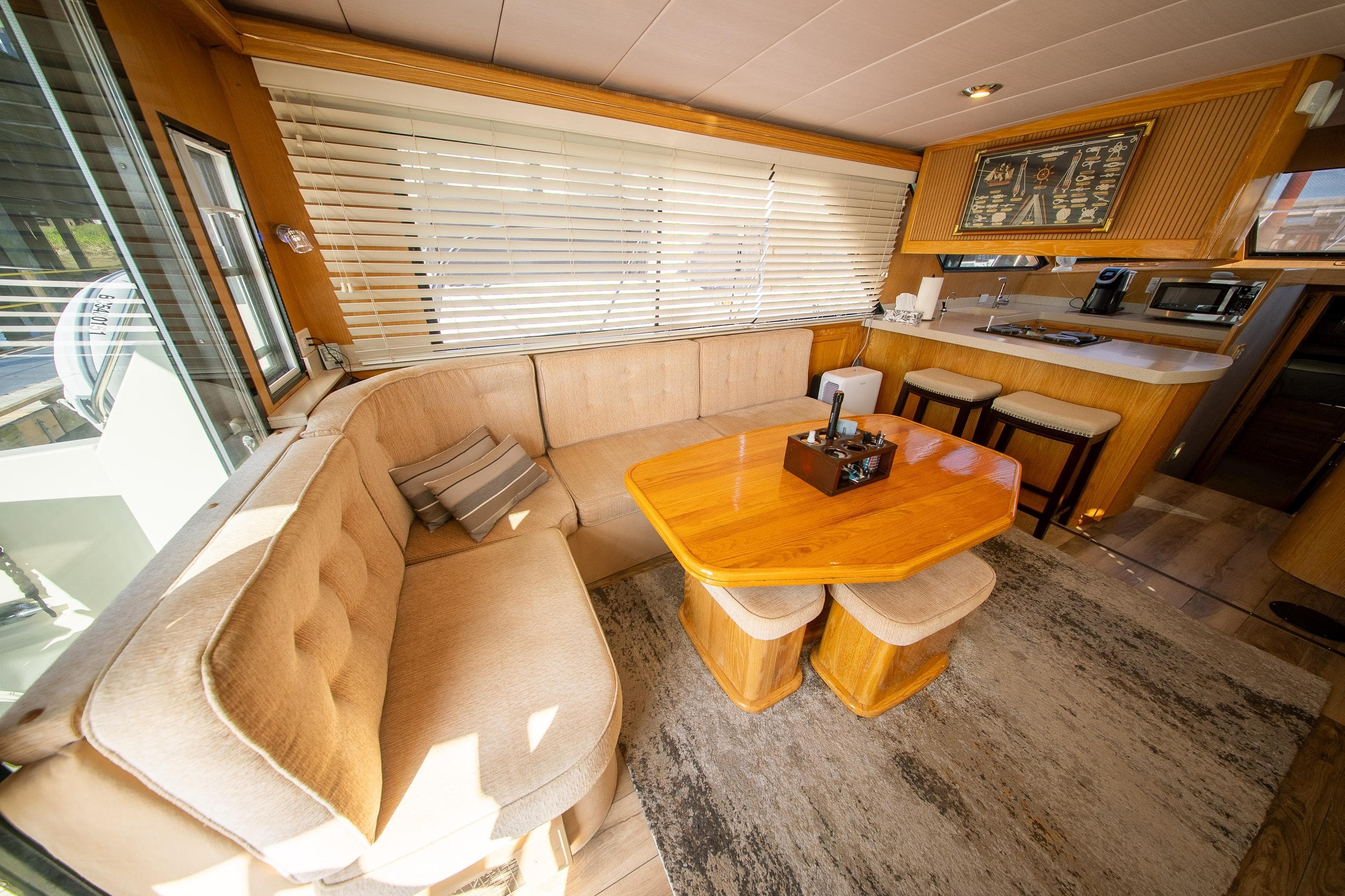 Luxurious interior of 1990 Tollycraft 44 Sedan yacht with cozy seating and dining area.