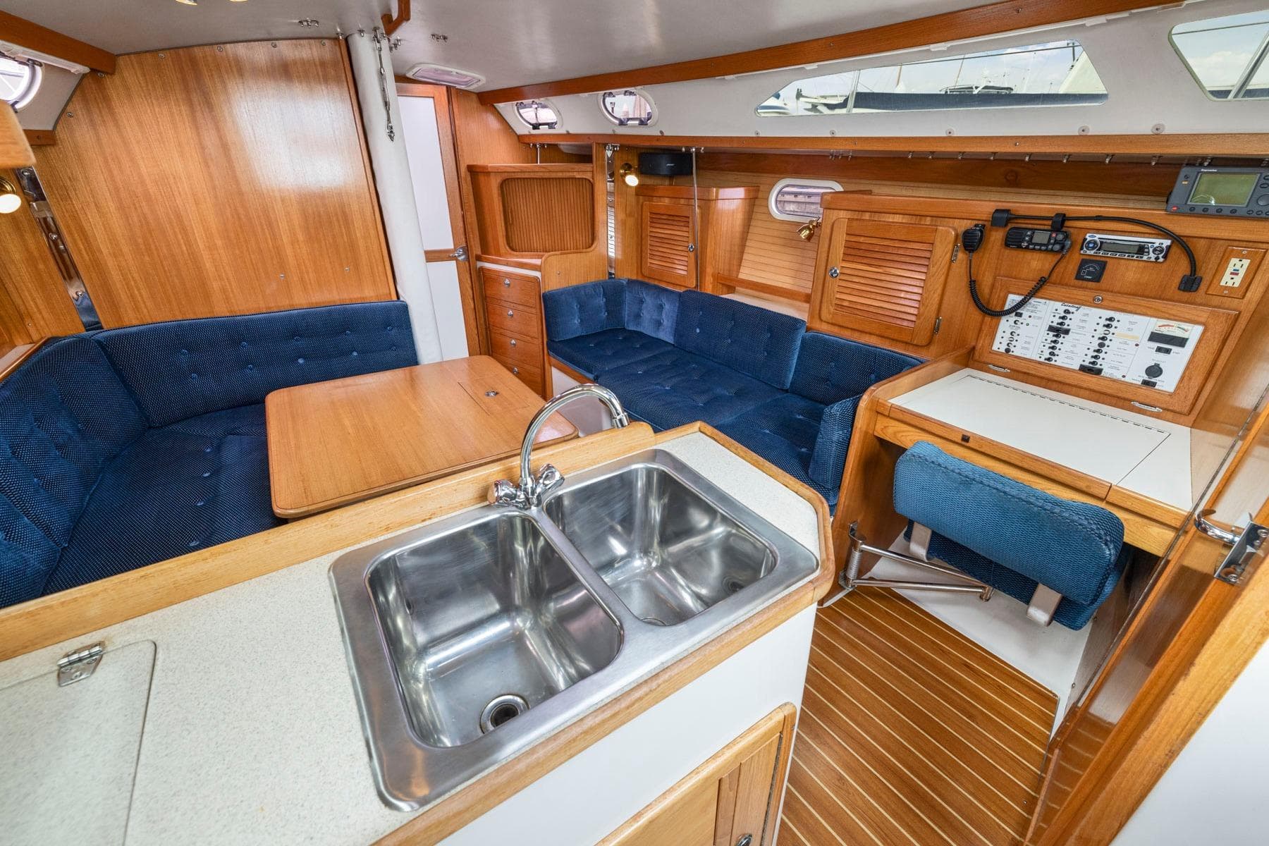 Interior of a 2004 Catalina 36 MkII sailboat with wood finish and blue seating.