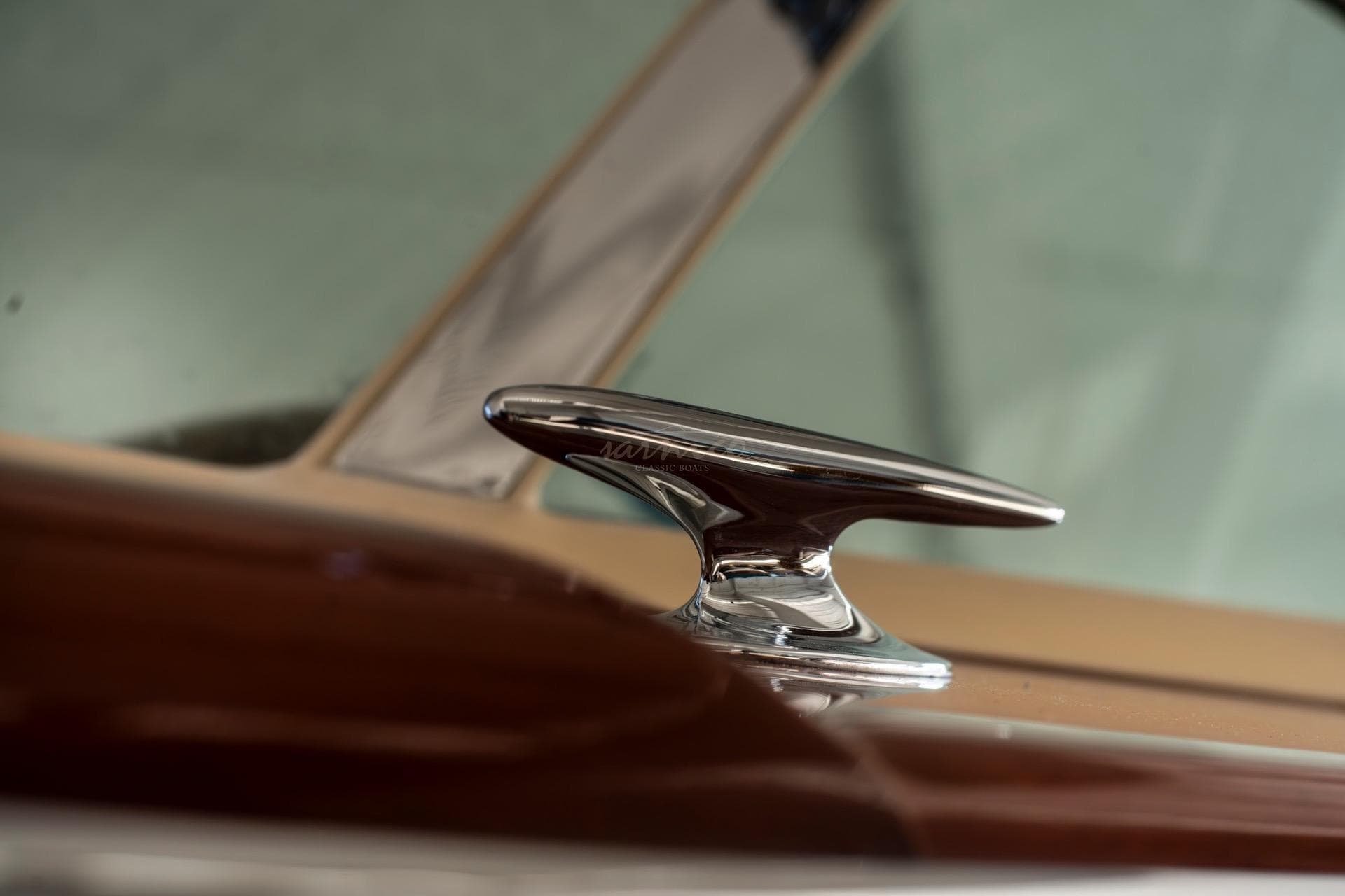 Close-up of a 1967 Riva Aquarama boat cleat, showcasing polished chrome detail.