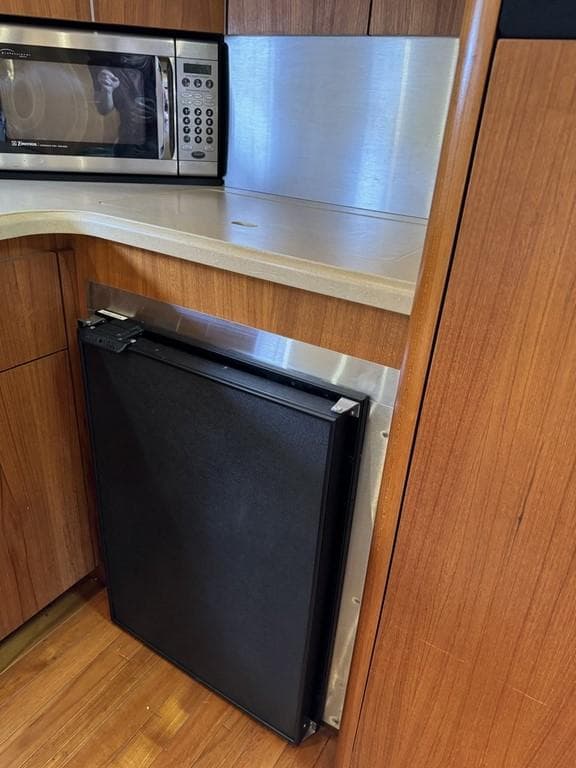 2004 Tiara Yachts 3600 Sovran kitchen with microwave and compact fridge.