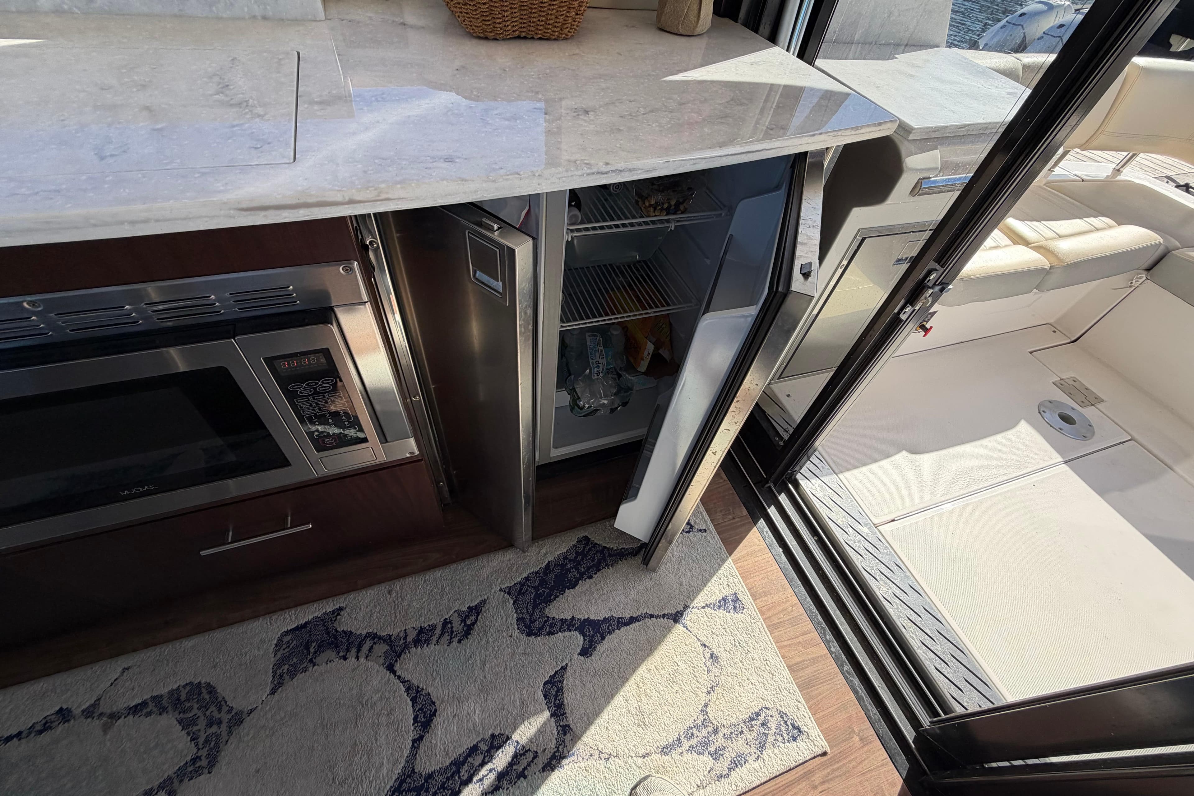 2019 Regal 42 Grande Coupe yacht interior with open fridge and microwave.