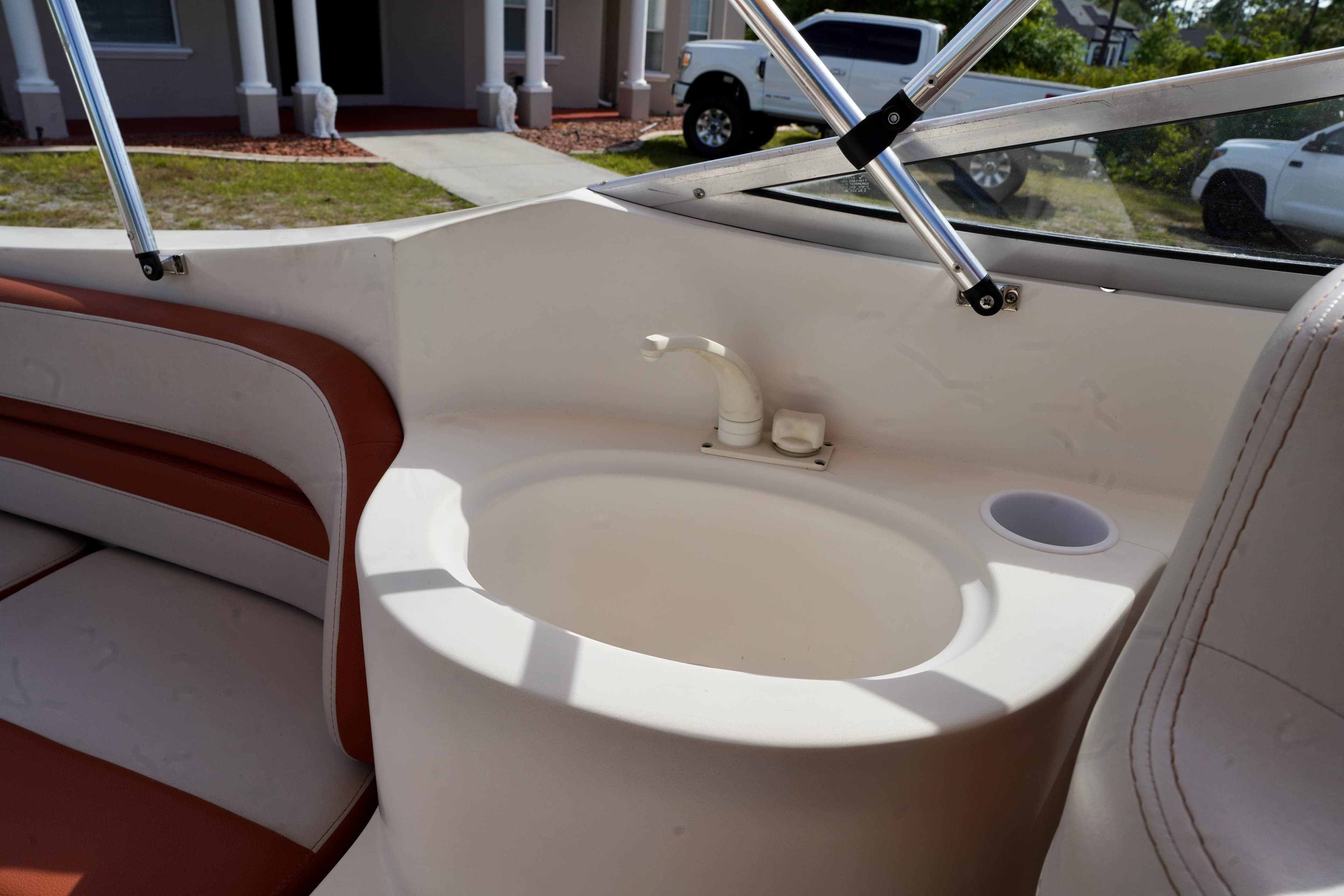 2001 Stingray 240 LS boat interior with sink and seating area.
