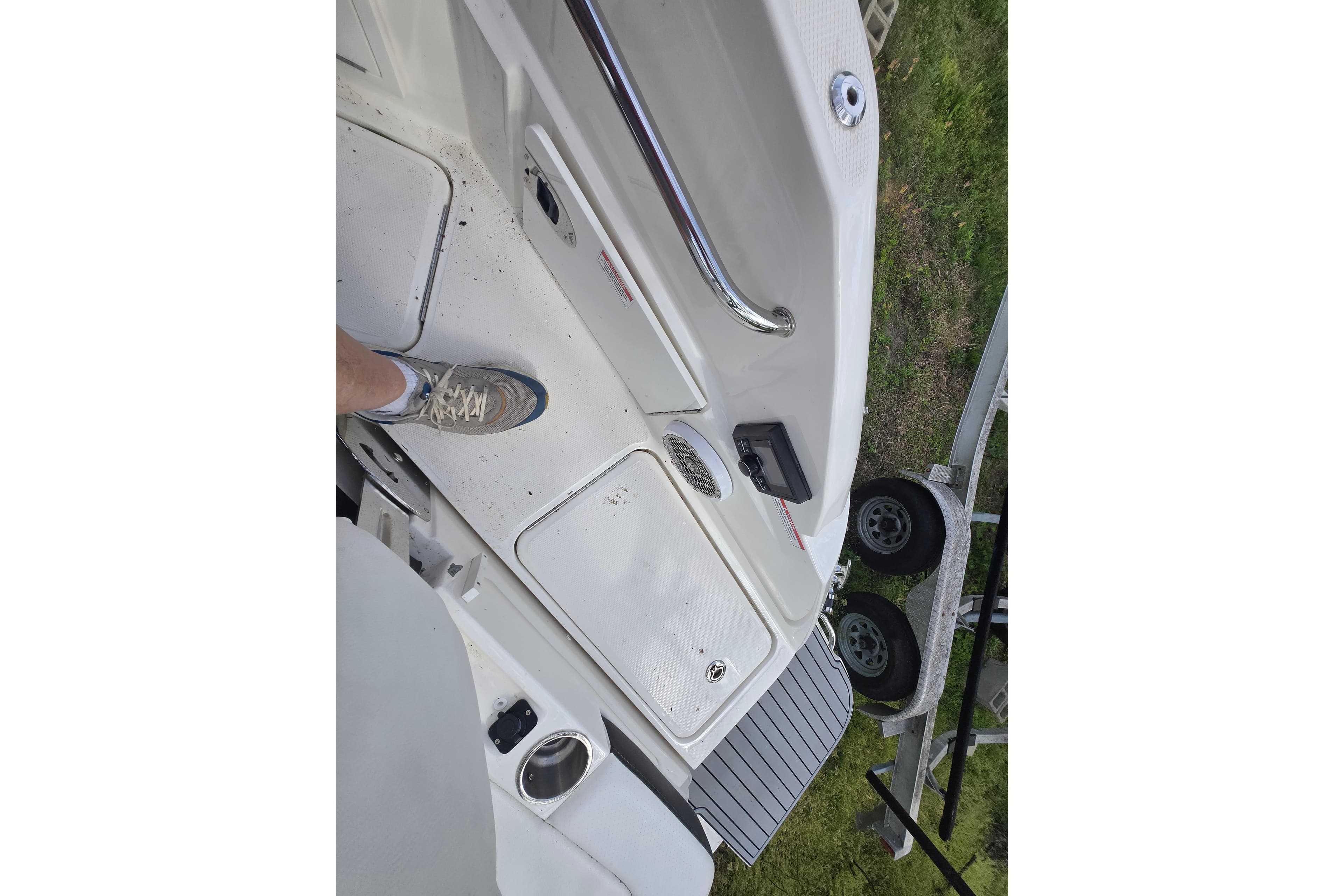 2018 Sea Ray SDX 250 boat deck with foot and trailer visible.