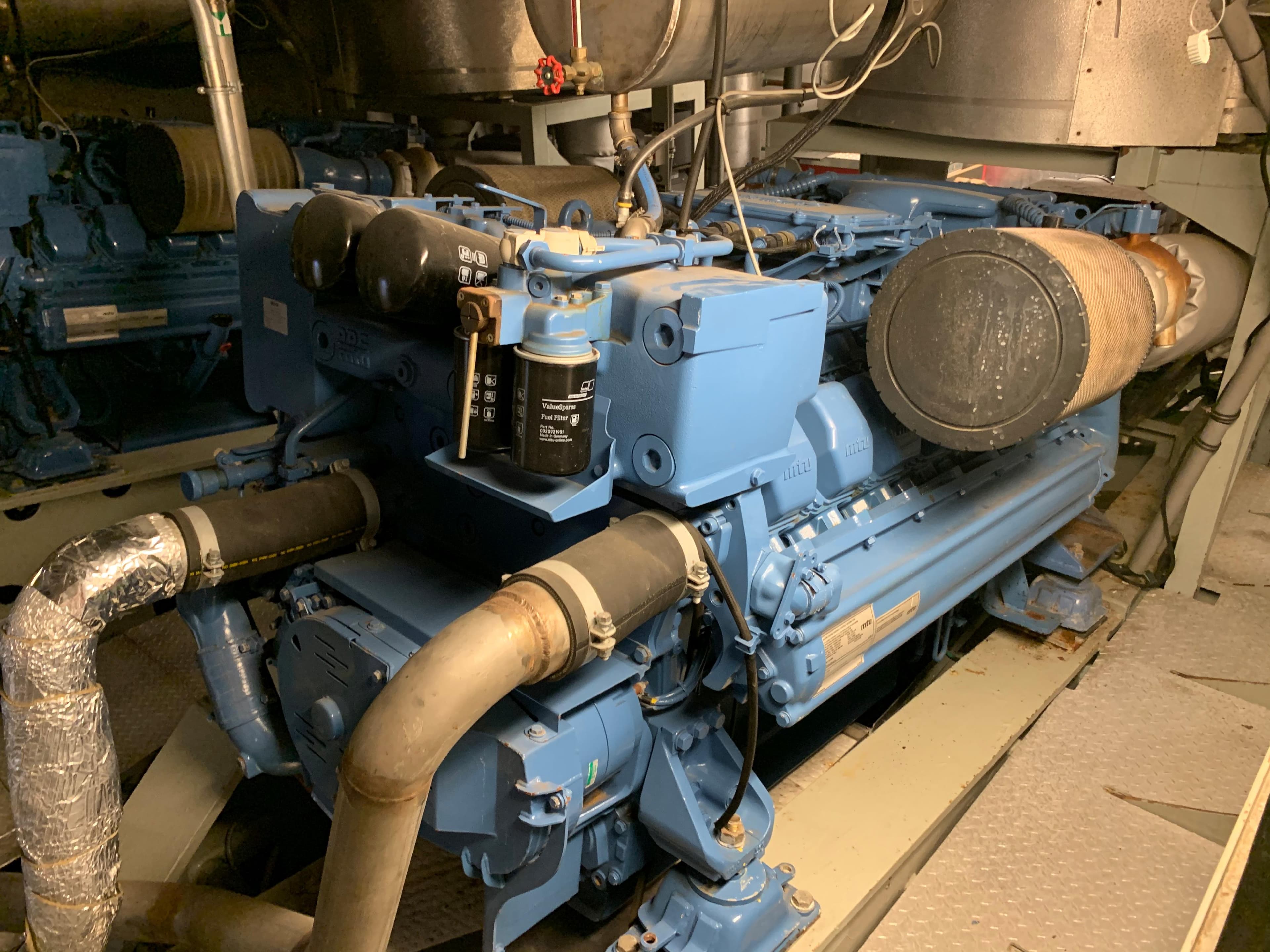 Engine room of a 2012 Ferry, showcasing a blue marine engine.