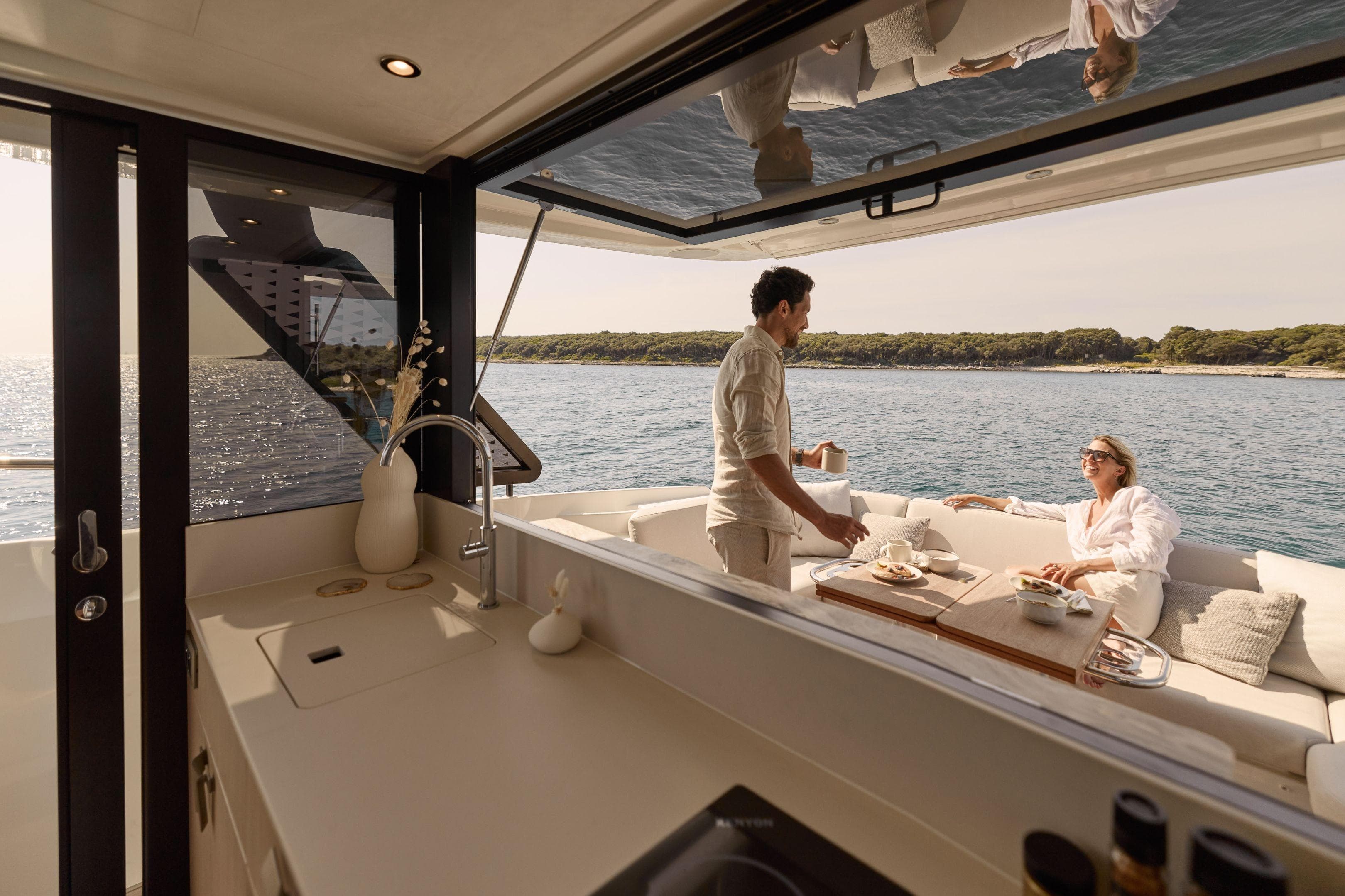 Luxurious Prestige F4.3 yacht interior with couple dining, ocean view, 2026 model.