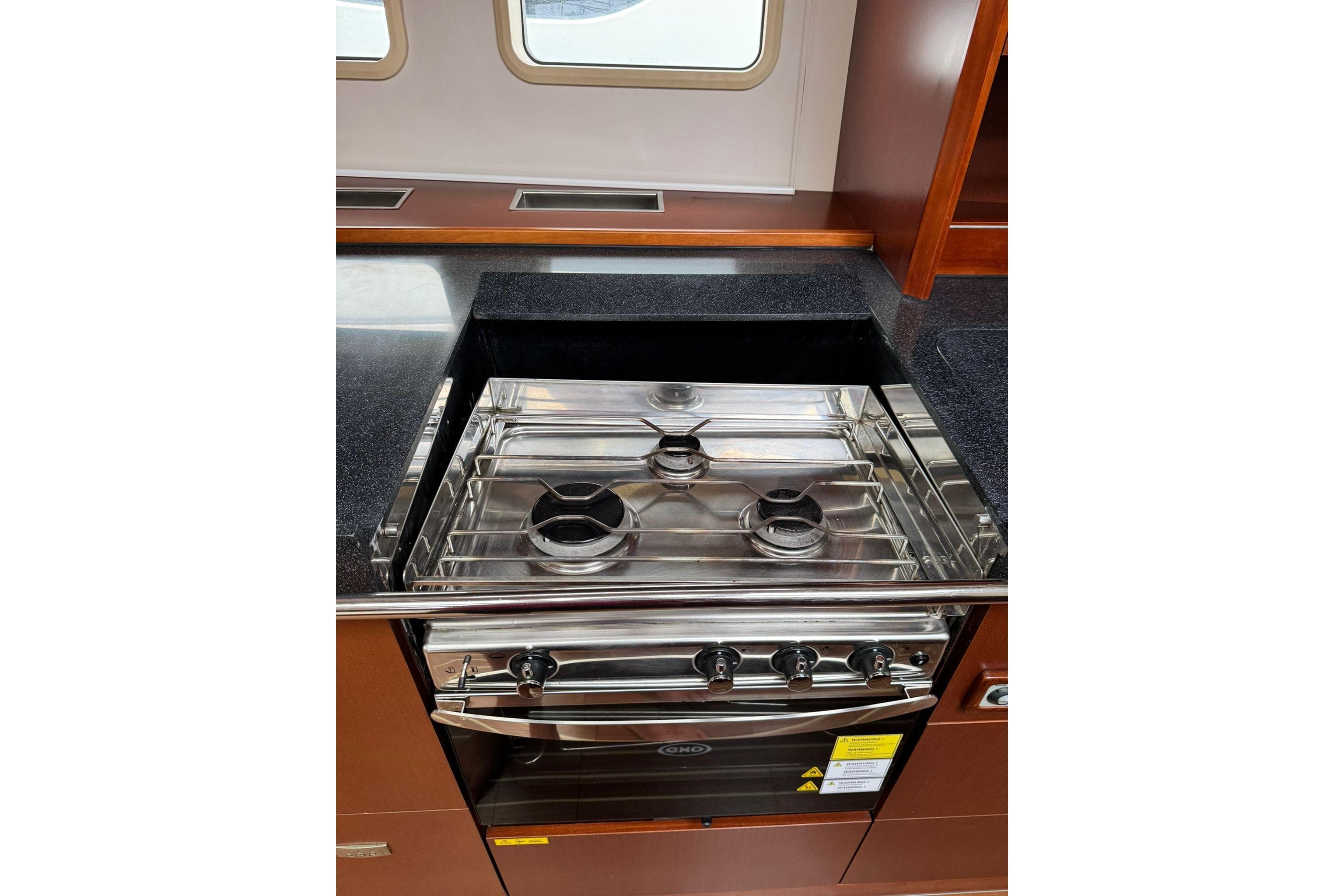 Stainless steel stove in 2014 Hanse 575 yacht kitchen, featuring sleek countertops and cabinetry.