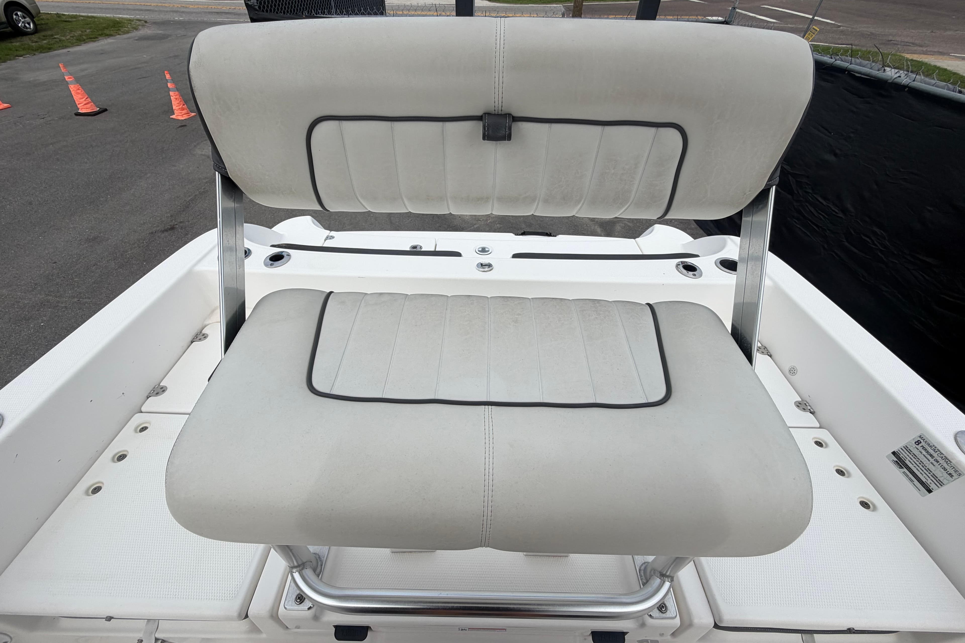 2018 Yamaha Boats 190 FSH seat with white upholstery and metal frame.
