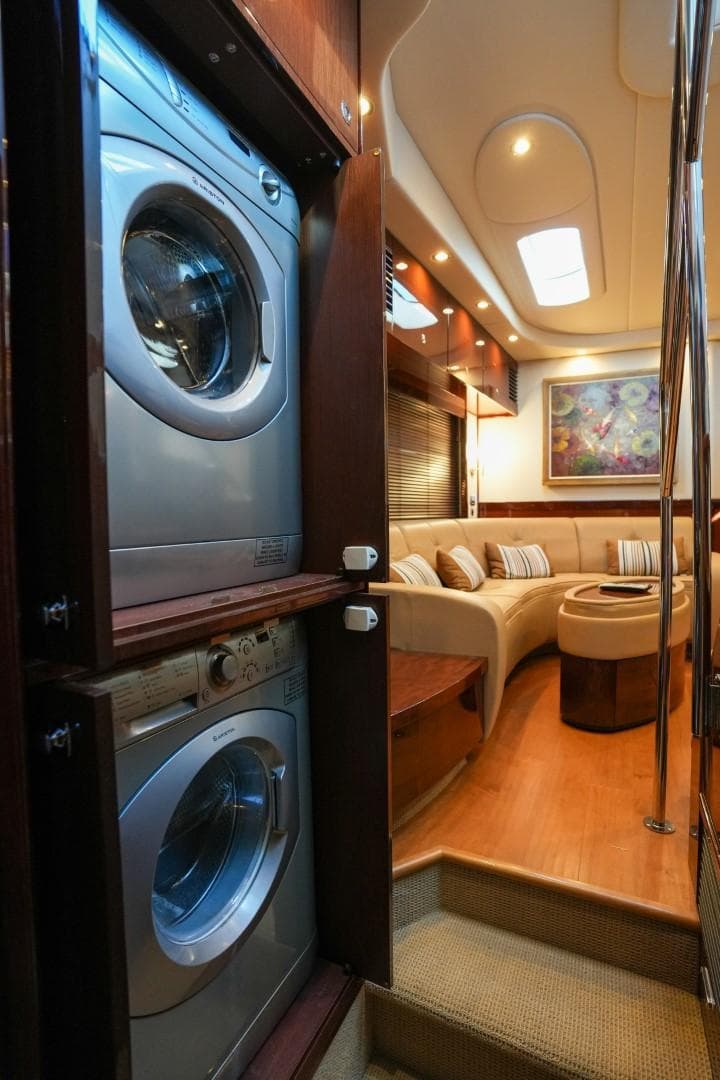 2013 Sea Ray 610 Sundancer interior with washer-dryer and cozy seating area.