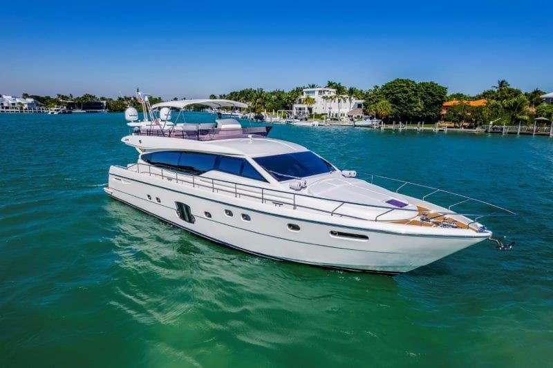Luxurious 2011 Ferretti Yachts 660 cruising on turquoise waters under clear blue skies.