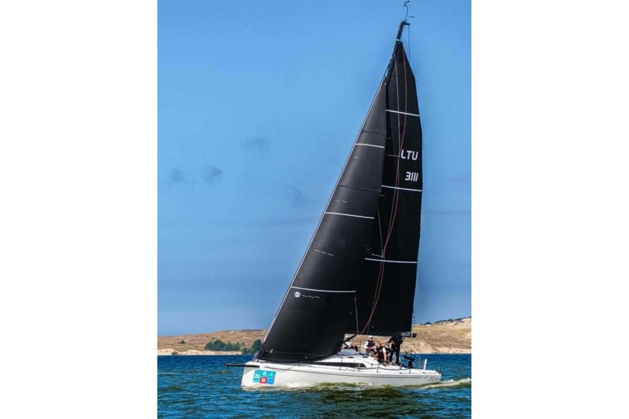 Sailboat Neo 350 (2018) with black sails on a sunny day at sea.