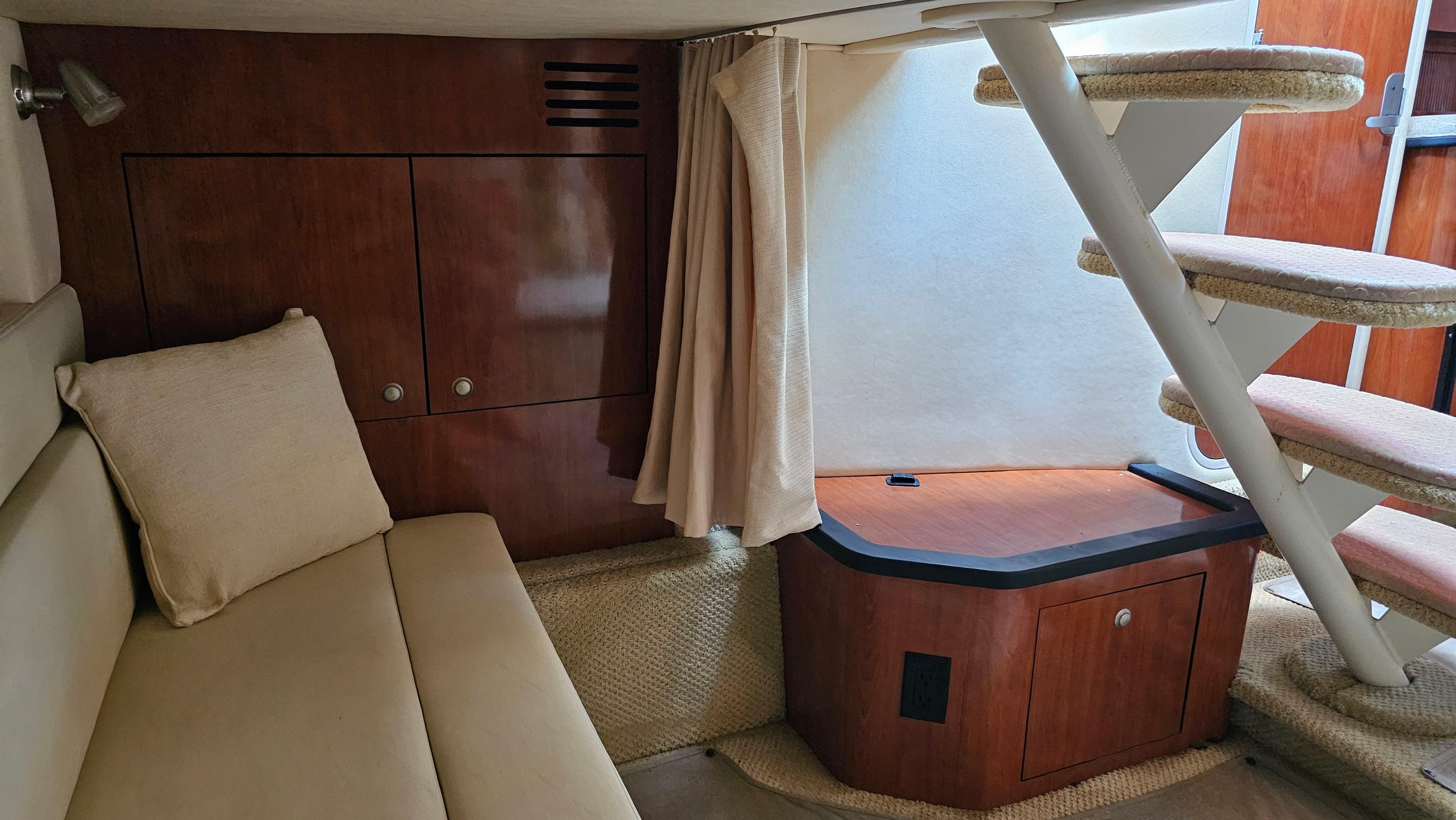 Interior of 2007 Sea Ray 340 Sundancer with beige seating and wooden cabinetry.