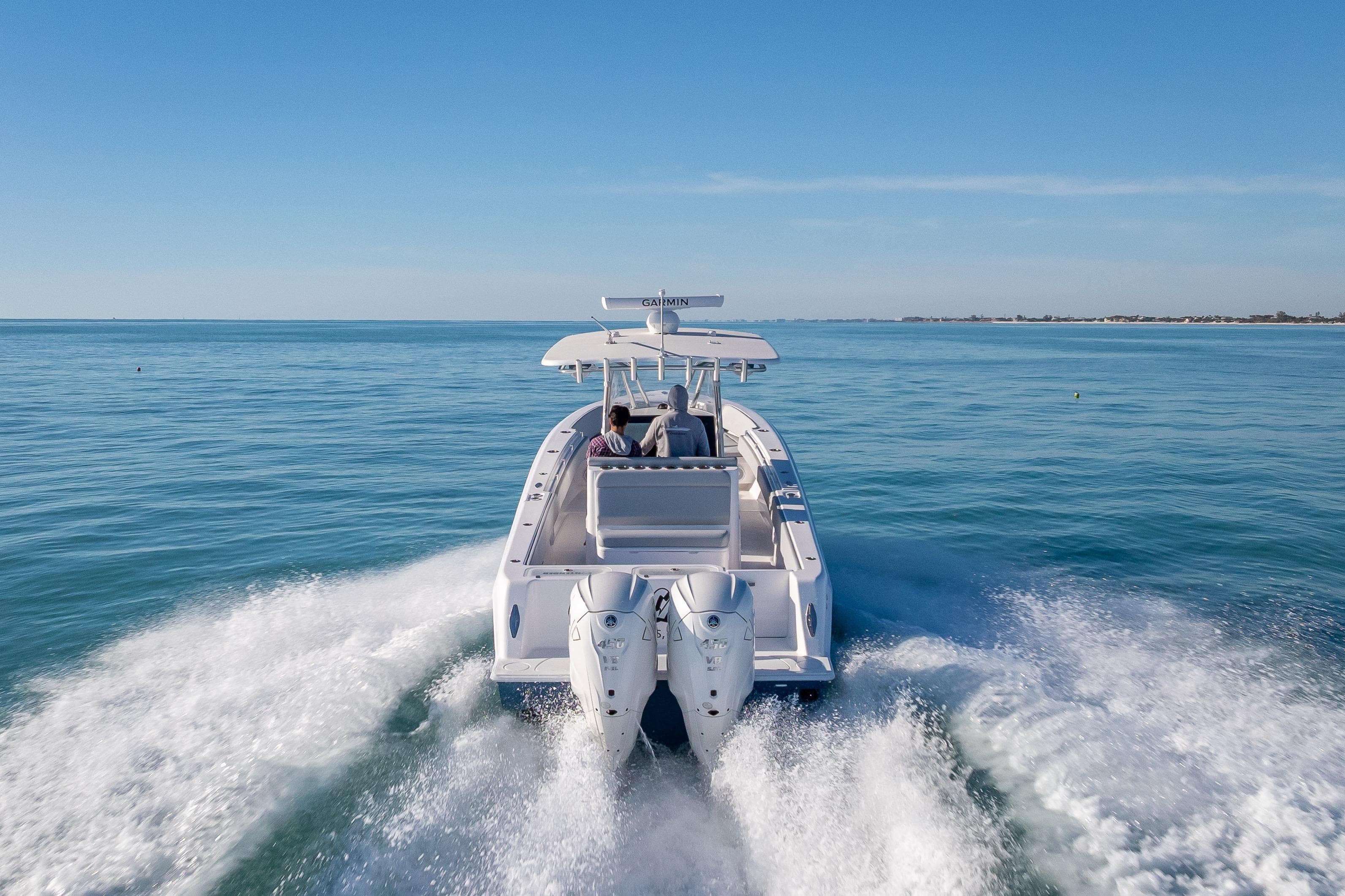 2026 Contender 35 ST boat cruising on open water, rear view.